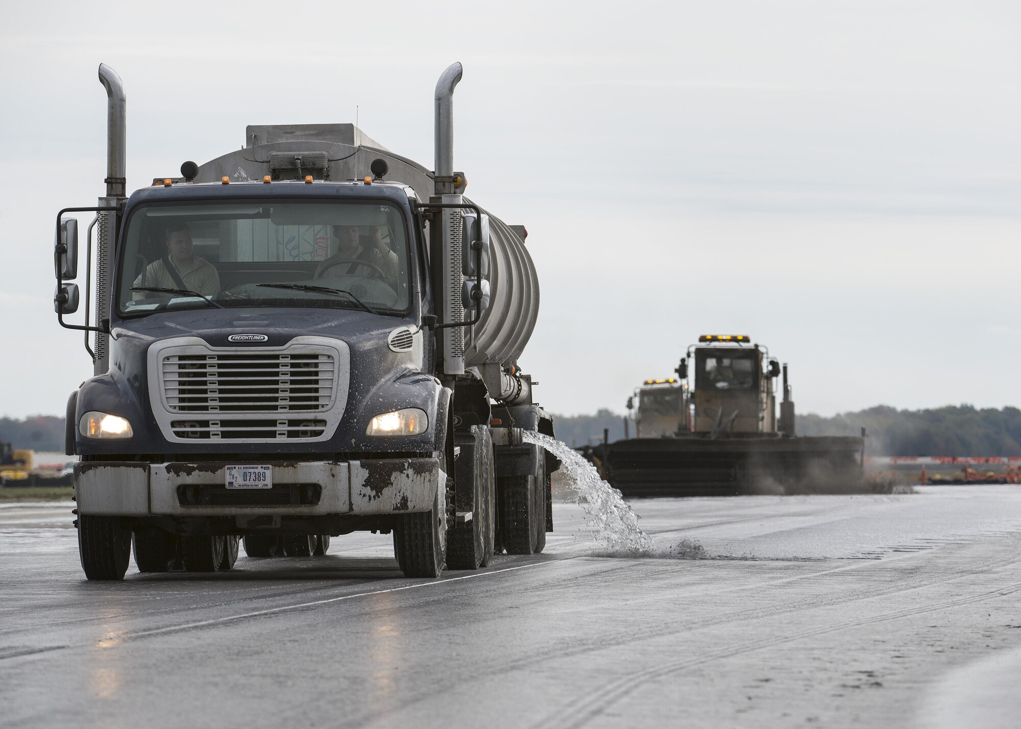 A water tanker truck disperses water onto Runway 14-32 during rubber removal operations Nov. 1, 2016, at Dover Air Force Base, Del. The 436th Civil Engineer Squadron’s Heavy Repairs Flight, also known as the ‘Dirt Boys,’ works in coordination with the 436th Operations Support Squadron’s Airfield Management to facilitate rubber removal. (U.S. Air Force photo by Senior Airman Zachary Cacicia)