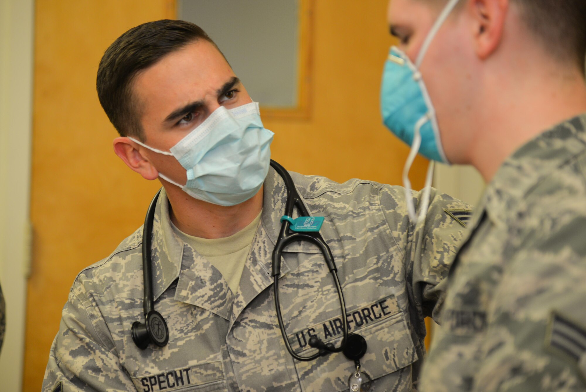 U.S. Air Force Senior Airman Kaleb Specht, 88th Medical Group medic, speaks with exercise participant to assist in diagnosing the scenario symptoms during a base exercise, Nov. 3, 2016 at Wright-Patterson Air Force Base, Ohio. Members of the 88th Air Base Wing Medical Group participated in an exercise this last week to test their level of readiness to respond to a simulated outbreak of Swine Flu. (U.S. Air Force photo / Staff Sgt. Ashley Clingerman)