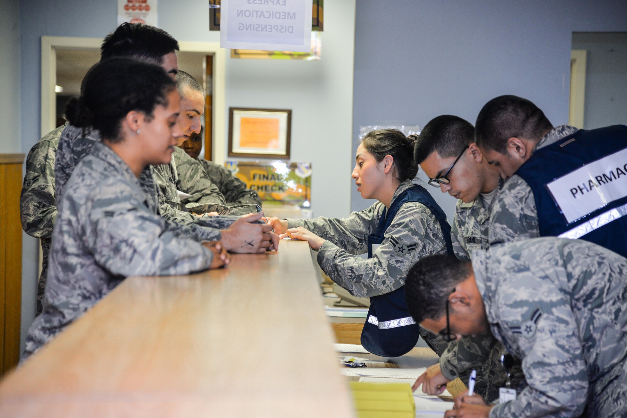 88th Medical Group pharmacy technicians assist exercise participants as they process through the medical line during a base exercise, Nov. 3, 2016 at Wright-Patterson Air Force Base, Ohio. Members of the 88th Air Base Wing Medical Group participated in an exercise this last week to test their level of readiness to respond to a simulated outbreak of Swine Flu. (U.S. Air Force photo / Staff Sgt. Ashley Clingerman)
