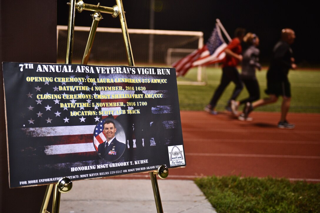 Members of the 932nd Airlift Wing carry the American flag around the Scott Air Force Base James Gym track in honor of Master Sgt. Gregory T. Kuhse during the 7th Annual Air Force Sergeants Association Vigil Run Nov. 5, 2016, Scott Air Force Base, Illinois.  Kuhse, who was assigned to Scott Air Force Base, was killed in a helicopter crash in Kabul, Afghanistan in October of 2015.  Each year the AFSA Vigil Run honors a local military veteran.  (U.S. Air Force photo by Christopher Parr)
