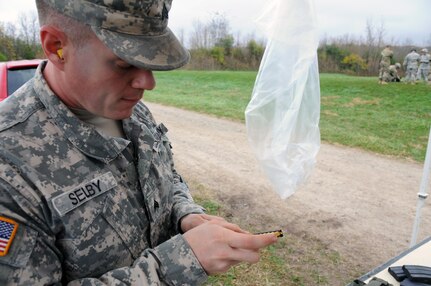 Sgt. Thomas Selby, a supply noncommissioned officer for the U.S. Army Reserve’s 318th Press Camp Headquarters, loads 5.56 mm caliber ammunition for soldiers from the 318th who were qualifying with their individually assigned weapon at Camp Atterbury, Indiana Nov. 3.