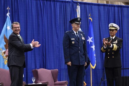 Secretary of Defense Ash Carter (left) and former commander of U.S. Strategic Command (USSTRATCOM) Adm. Cecil D. Haney (right) congratulate new USSTRATCOM commander Gen. John E. Hyten during a change of command ceremony at Offutt Air Force Base, Neb., Nov. 3, 2016. Carter presided over the change of command and provided remarks during which he congratulated Hyten on his appointment and thanked Haney for his service. Additionally, Chairman of the Joint Chiefs of Staff Gen. Joseph F. Dunford provided remarks during the ceremony and presented the Joint Meritorious Unit Award to USSTRATCOM. Hyten previously served as commander of Air Force Space Command, and Haney will retire from active military duty during a separate ceremony in January. One of nine DoD unified combatant commands, USSTRATCOM has global strategic missions assigned through the Unified Command Plan that include strategic deterrence; space operations; cyberspace operations; joint electronic warfare; global strike; missile defense; intelligence, surveillance and reconnaissance; combating weapons of mass destruction; and analysis and targeting. (U.S. Air Force photo by Staff Sgt. Jonathan Lovelady) 