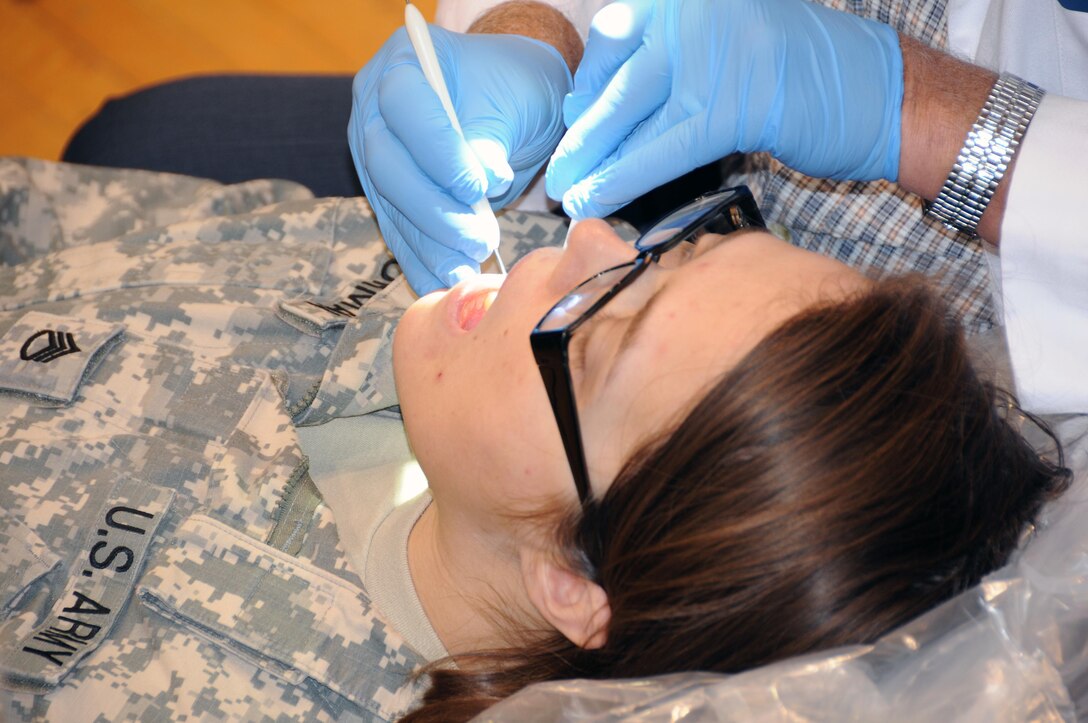 Staff Sgt. Nondice Thurman, a public affairs broadcast specialist from Clarksville, Tennessee assigned to the U.S. Army Reserve’s 372nd Mobile Public Affairs Detachment, has her teeth checked during a mass medical event Nov. 4. at Muscatatuck Urban Training Center, Indiana.  Mass medical events are designed to help local unit commanders who want to increase their medical readiness in a short amount of time.