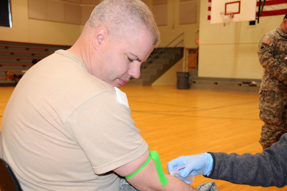 Sgt. 1st Class Daniel Symonds, assigned to the U.S. Army Reserve’s 318th Press Camp Headquarters, has blood drawn during a mass medical event Nov. 4. at Muscatatuck Urban Training Center, Indiana.  Mass medical events are designed to help local unit commanders who want to increase their medical readiness in a short amount of time.