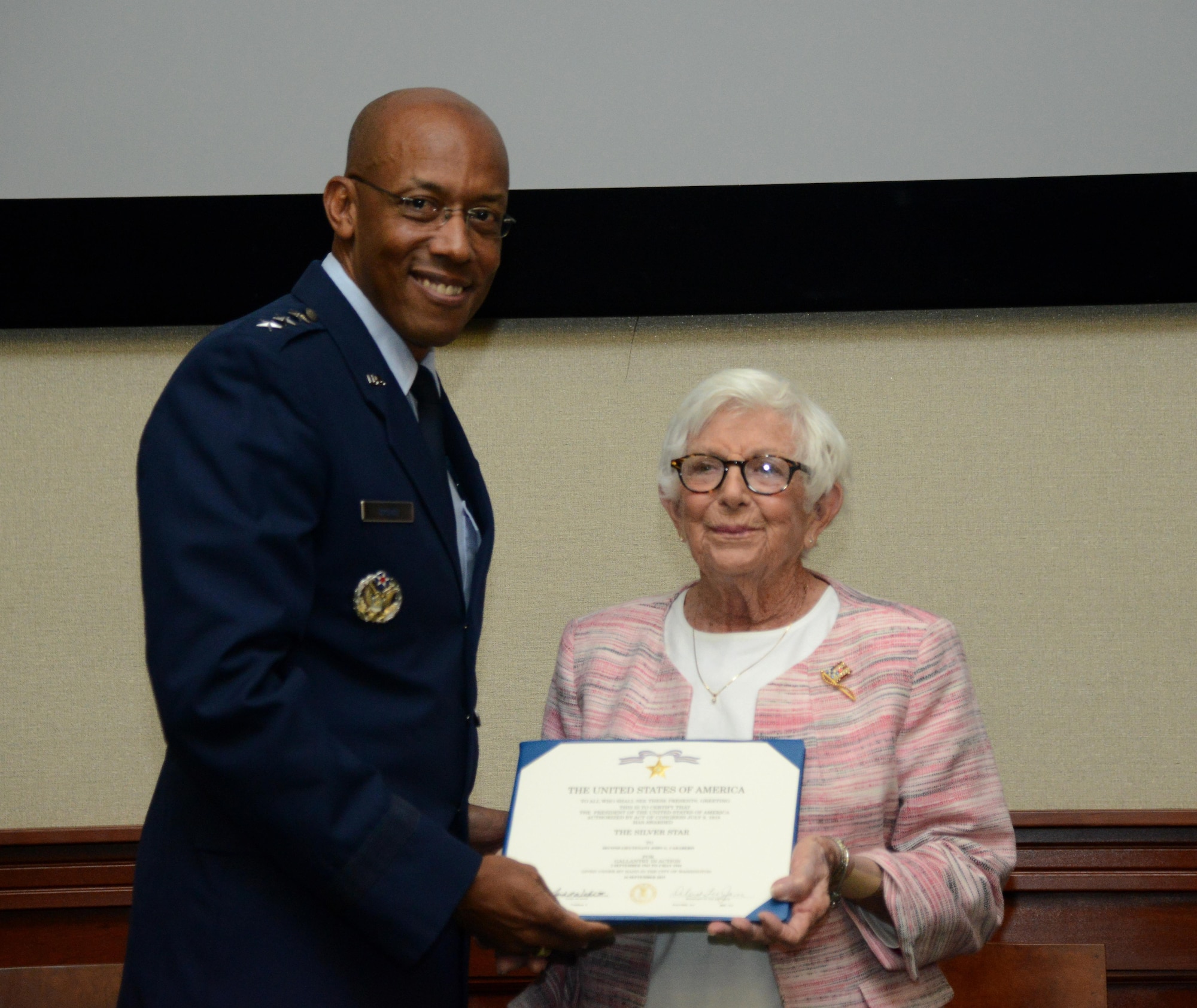 Margaret Caraberis, right, accepts the Silver Star on behalf of her husband, John Caraberis, at MacDill Air Force Base, Fla., Nov. 4, 2016. Margaret Caraberis was asked to receive the Silver Star Medal, which was awarded to John Caraberis posthumously for his heroic acts in service to his country. 