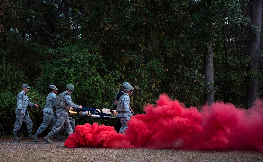 A team of medics transport a simulated casualty to a helicopter after an attack, during an Emergency Medical Technician refresher course, Nov. 4, 2016, at Moody Air Force Base, Ga. Medics navigated through smoke and debris, which altered their route to get the patients to safety. (U.S. Air Force photo by Airman 1st Class Janiqua P. Robinson)