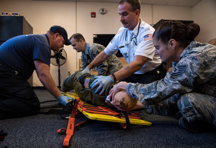 Students place a simulated casualty onto a gurney during an Emergency Medical Technician refresher course, Oct. 31, 2016, at Moody Air Force Base, Ga. During this skills assessment, evaluators made sure students correctly treated and evaluated injuries, used proper techniques to decrease the risk of further injury and used equipment properly to maintain the patient’s safety. (U.S. Air Force photo by Airman 1st Class Janiqua P. Robinson)