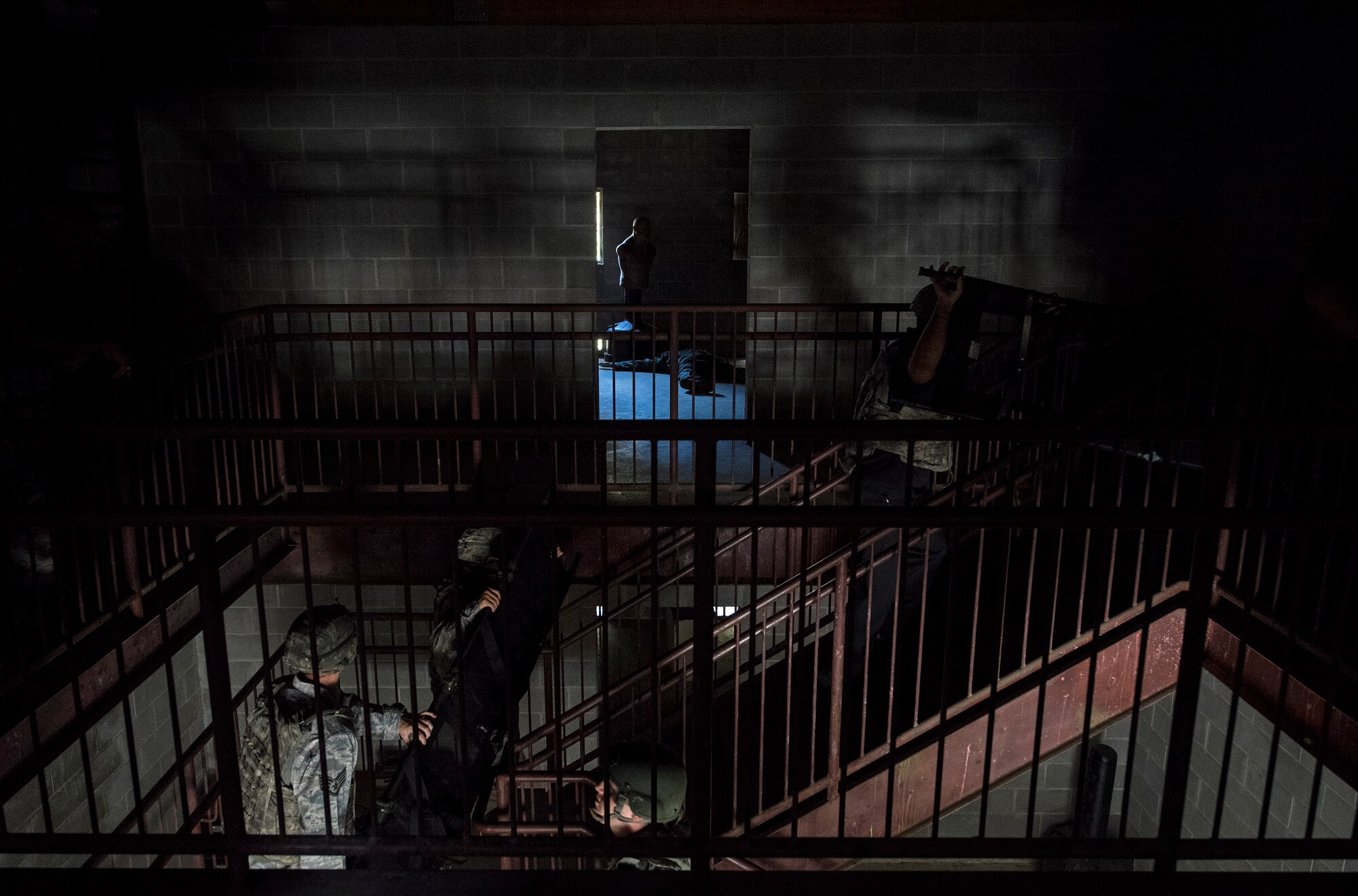 A team of medics enter a building to retrieve casualties after a simulated attack, during an Emergency Medical Technician refresher course, Nov. 4, 2016, at Moody Air Force Base, Ga. The medics were tasked to recover and treat four simulated casualties, strap them onto gurneys, safely carry them out of the village and load them into helicopters. (U.S. Air Force photo by Airman 1st Class Janiqua P. Robinson)