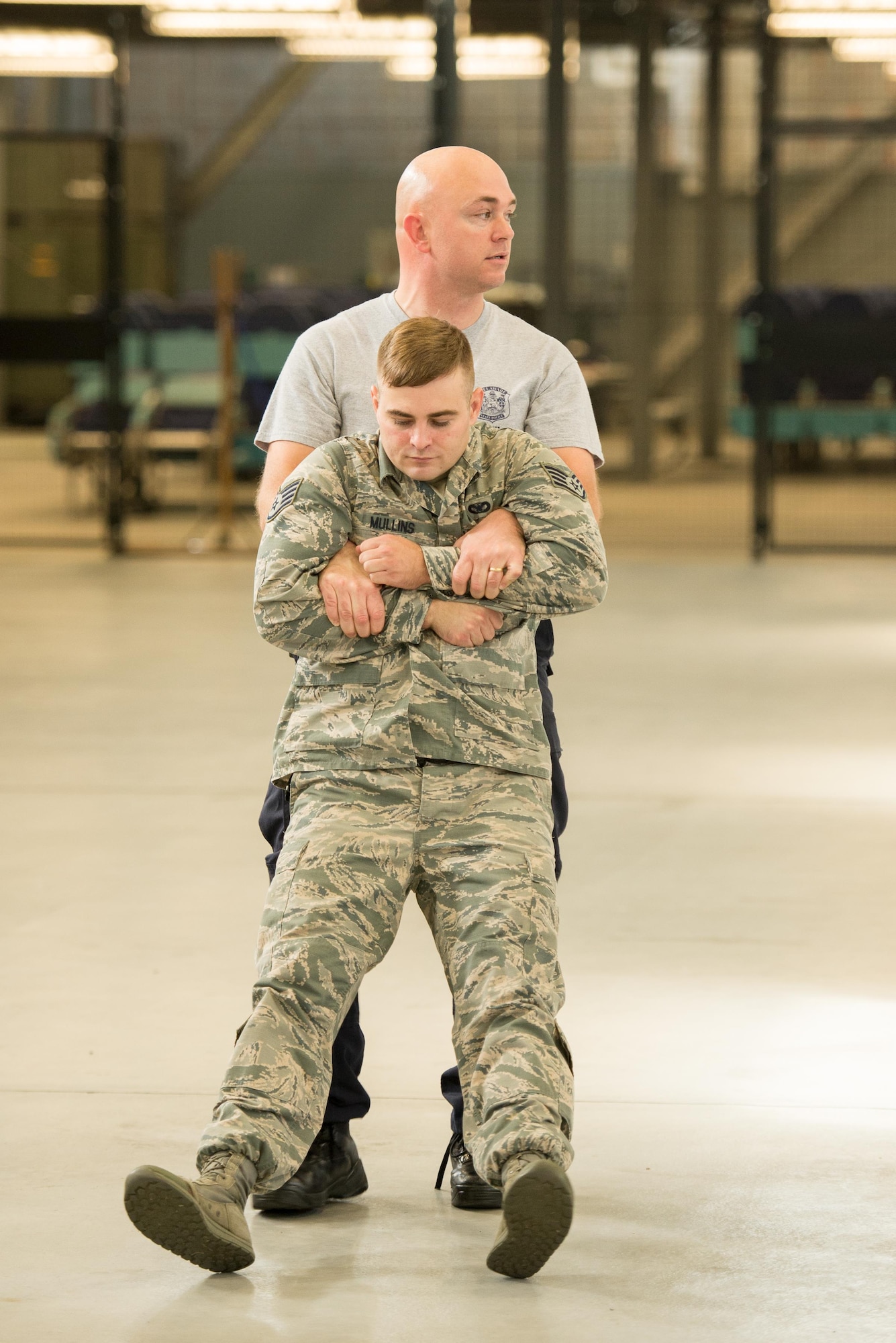 Senior Cpl. Jason Baxley, Delaware State Police Tactical Control Unit defensive tactics instructor, demonstrates safely transporting a non-compliant protestor from a seated position Nov. 3, 2016, on Dover Air Force Base, Del. Baxley was one of 35 Delaware State Police officers who visited with security forces members at Dover AFB to share tactics and weapons knowledge. (U.S. Air Force photo by Mauricio Campino)
