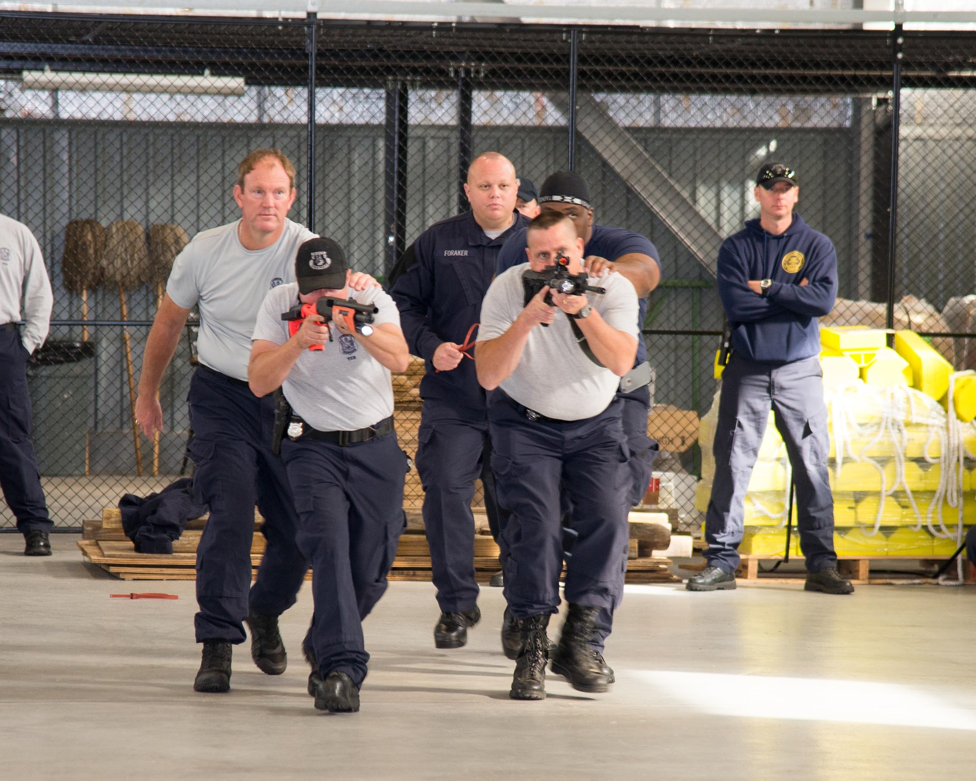 Officers of Delaware State Police Tactical Control Unit demonstrate an arrest team using side-by-side deployment of lethal and non-lethal weapons during a riot control scenario Nov. 3, 2016, on Dover Air Force Base, Del. This tactic allows the officers to take control of the situation using the minimum amount of force necessary. (U.S. Air Force photo by Mauricio Campino)