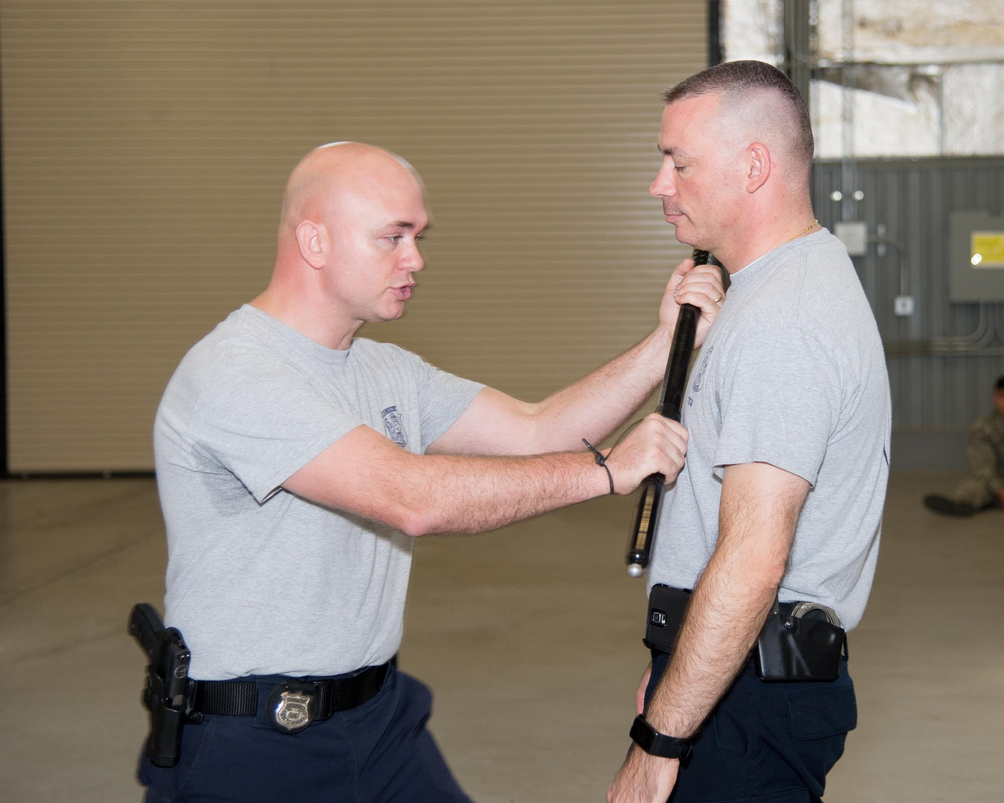 Senior Cpl. Jason Baxley, Delaware State Police Tactical Control Unit defensive tactics instructor, demonstrates baton skills for crowd control Nov. 3, 2016, on Dover Air Force Base, Del. Baxley, who also serves as the medic for the TCU, was one of 35 Delaware State Police Officers who trained with Dover AFB security forces members. (U.S. Air Force photo by Mauricio Campino)