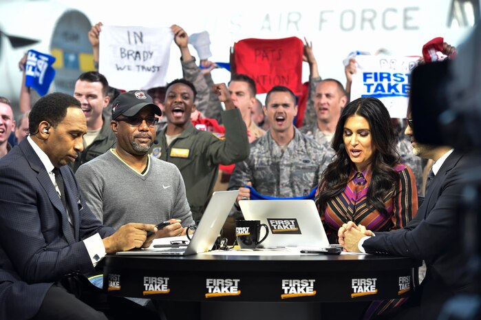 Molly Qerim, ESPN First Take host, is joined by Stephen A. Smith, Max Kellerman and Darius Rucker, Grammy Award-winning singer and songwriter, broadcasting live here as part of their week of Veteran’s Day program, Nov. 7, 2016. Every year ESPN First Take honors service members near Veterans Day by telecasting their show from a different base and highlights service members who go above and beyond in their careers.