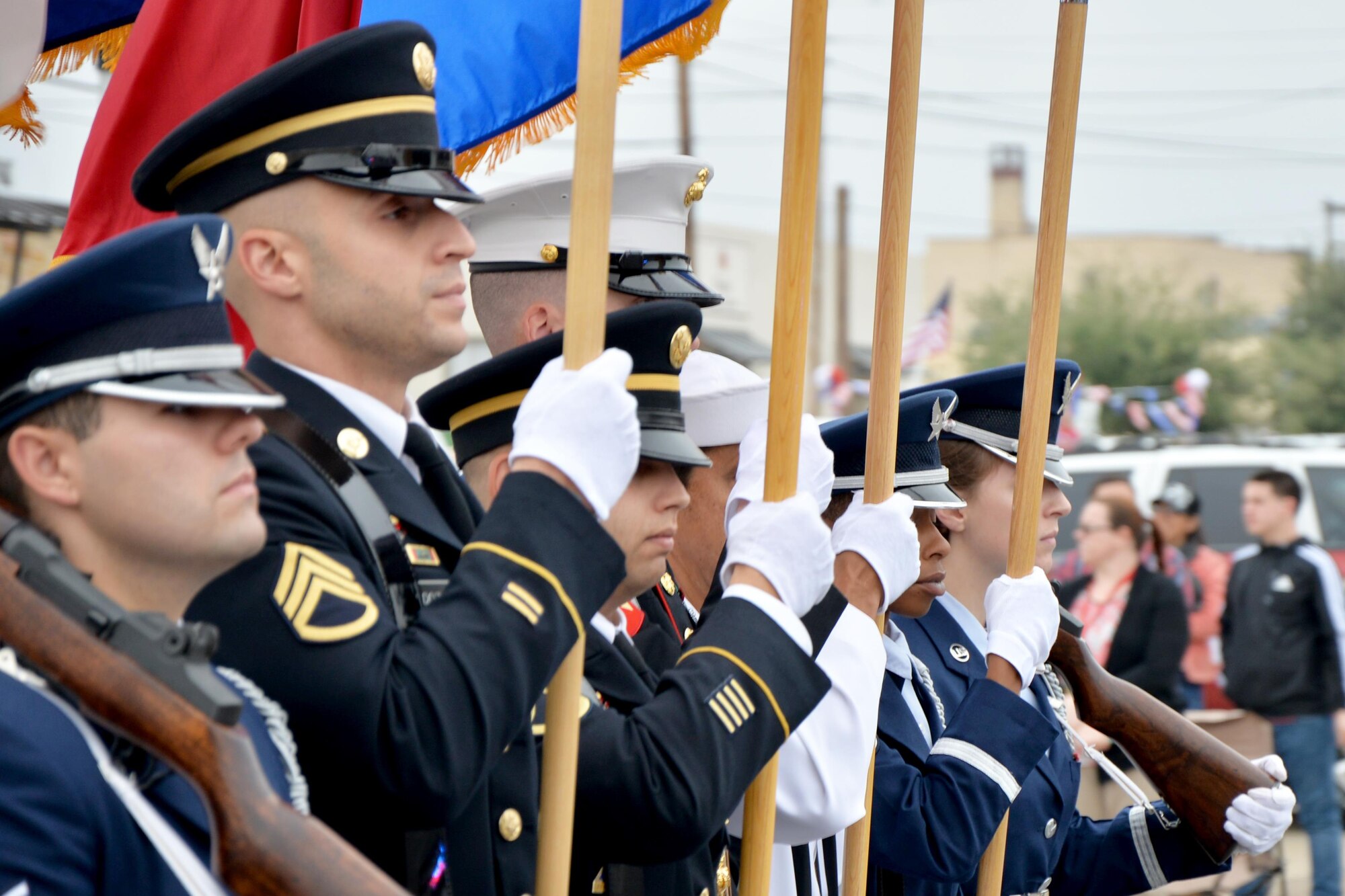 The Goodfellow Air Force Base Joint Service Color Guard marches in the Veterans Day Parade in downtown San Angelo, Texas, Nov. 5, 2016. Service members from the Army, Marine Corps, Navy, Air Force and Coast Guard participated to support the city. (U.S. Air Force photo by Airman 1st Class Randall Moose /Released) 