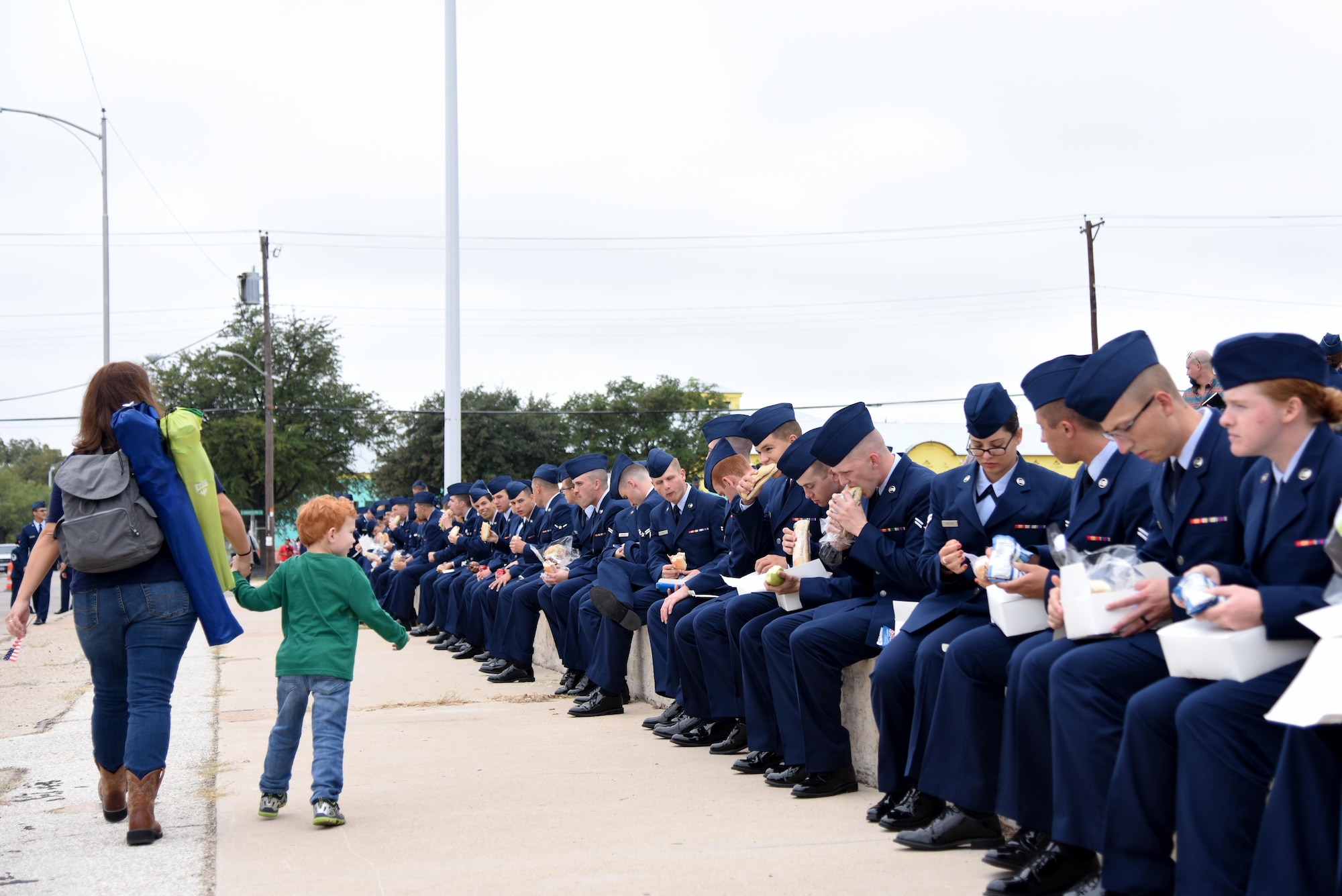 U.S. Air Force Airmen eat lunch after the Veterans Day Parade in downtown San Angelo, Texas, Nov. 5, 2016. Airmen from various squadrons on Goodfellow Air Force Base supported the parade by marching in formation. (U.S. Air Force photo by Senior Airman Joshua Edwards/Released) 