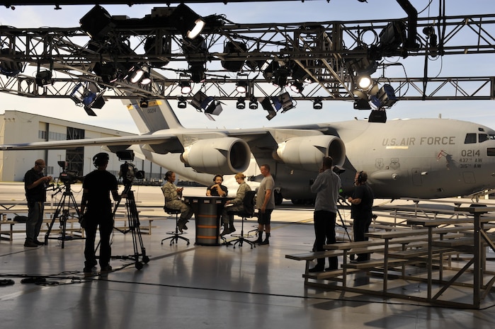 Members of Joint Base Charleston assist the production crew from ESPN's First Take television program set-up in Nose Dock 2, here, Nov. 6, 2016. ESPN First Take filmed a live show Nov. 7 in honor of Veteran's Day. 