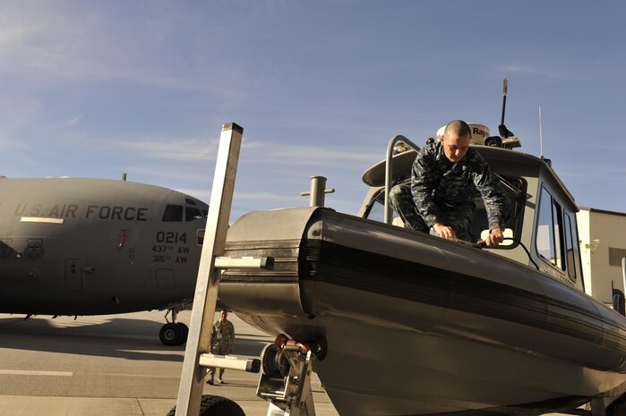 Petty Officer 2nd Class Kevin Labenki, a port ops engineer with the 628th Security Forces Squadron, prepares a harbor patrol boat as a static display in Nose Dock 2 supporting ESPN First Take television program, here, Nov. 6, 2016. ESPN2's First Take filmed a live show in honor of Veteran's Day. 