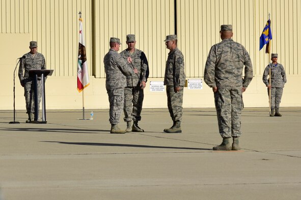 Chief Master Sgt. Gilbert Sanchez accepts an NCO sword Oct. 1, 2016, during an assumption of authority ceremony held at March Air Reserve Base, California, as he becomes Command Chief of the 163d Attack Wing. Sanchez joined the wing in 1998 after serving five years of active duty. During his career, Sanchez has worked in munitions and logistics. He served as first sergeant three times and also worked as the wing's human resource advisor. (U.S. Air National Guard photo by Tech. Sgt. Joseph McKee)