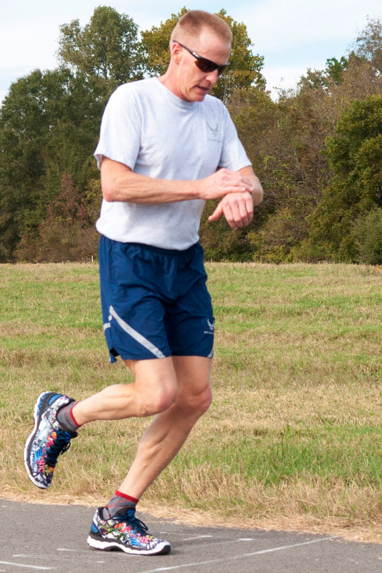 U.S. Air Force Chief Master Sgt. Scott Moeller, superintendent of the 707th Maintenance Squadron, stops his watch at 20 minutes and 48 seconds as he is the first to cross the finish line in the 2016 Turkey Trot 5k on Nov. 5, 2016, Barksdale Air Force Base, La. The run was hosted by the 307th Force Support Squadron and each participant was entered into a drawing for a Thanksgiving turkey. (U.S. Air Force photo by Tech. Sgt. Cody Burt/Released)
