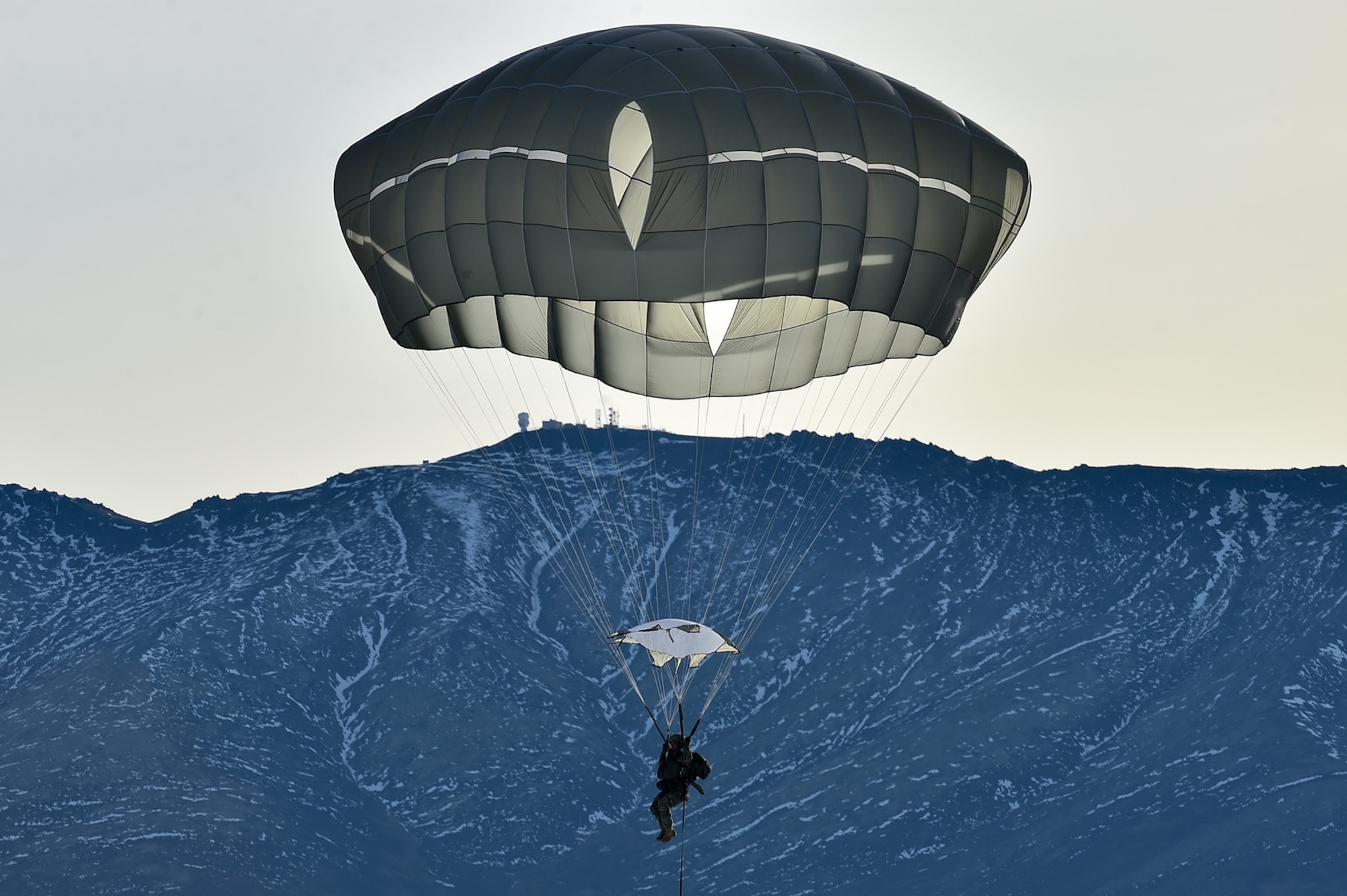 A U.S. Army paratrooper assigned to the 4th Infantry Brigade Combat Team (Airborne), 25th Infantry Division, U.S. Army Alaska, prepares to land during an airborne training jump from a CH-47 Chinook helicopter on Malemute drop zone at Joint Base Elmendorf-Richardson, Alaska, Thursday, Nov. 3, 2016. The Soldiers of 4/25 IBCT belong to the only American airborne brigade in the Pacific and are trained to execute airborne maneuvers in extreme cold weather/high altitude environments in support of combat, partnership and disaster relief operations. 