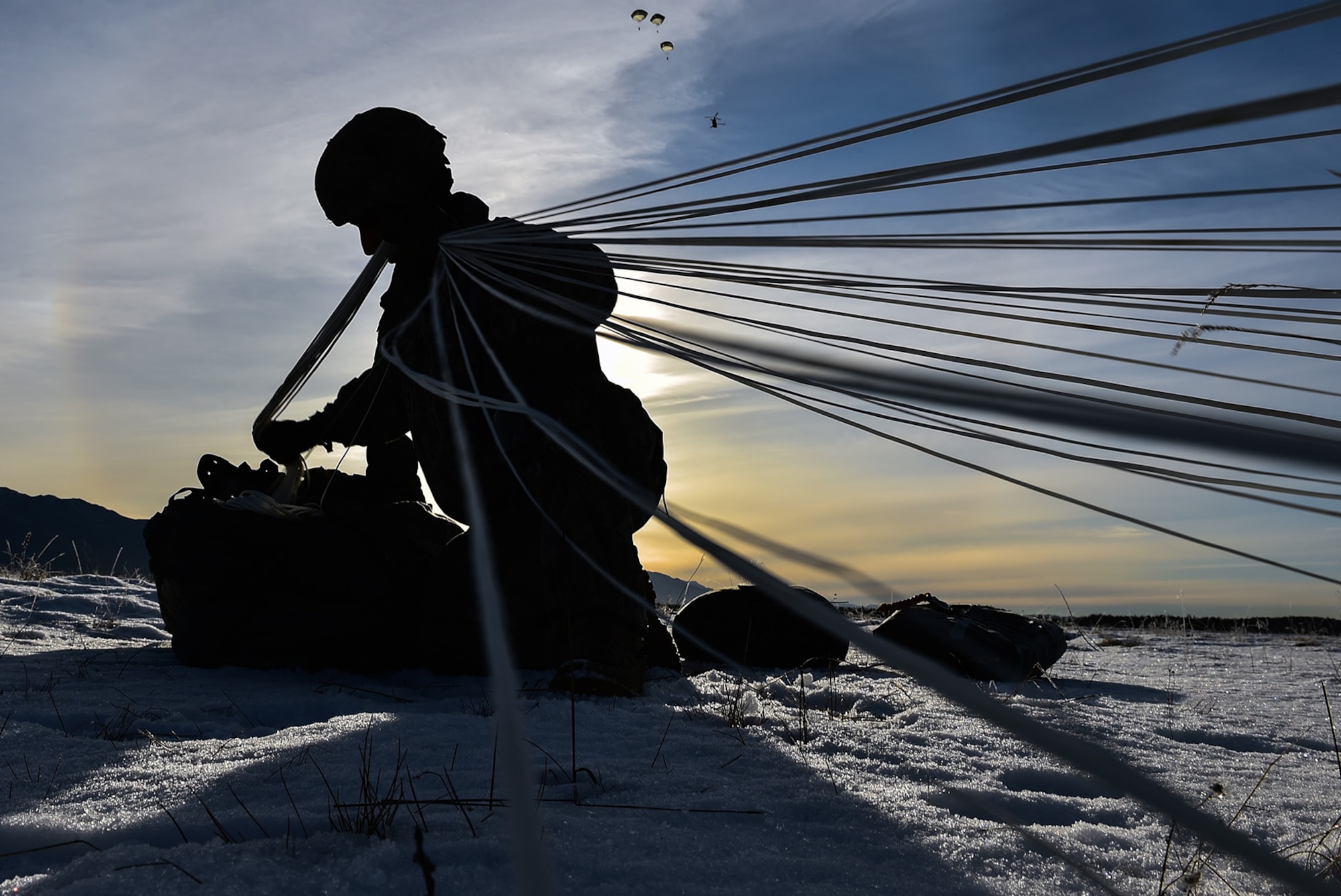 Spc. Wesley Madera-Lopez, a native of Long Beach, Calif., assigned to B Company, 6th Brigade Engineer Battalion (Airborne), 4th Infantry Brigade Combat Team (Airborne), 25th Infantry Division, U.S. Army Alaska, packs up his parachute after an airborne training jump from a CH-47 Chinook helicopter on Malemute drop zone at Joint Base Elmendorf-Richardson, Alaska, Thursday, Nov. 3, 2016. The Soldiers of 4/25 IBCT belong to the only American airborne brigade in the Pacific and are trained to execute airborne maneuvers in extreme cold weather/high altitude environments in support of combat, partnership and disaster relief operations. 