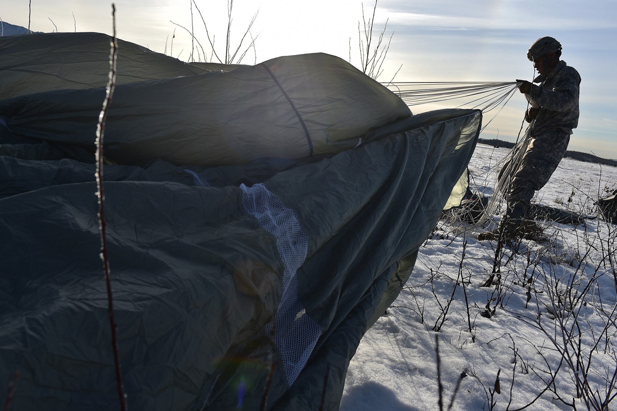 Spc. Dedrick McCluney, a native of Anniston, Ala., assigned to Easy Company, 6th Brigade Engineer Battalion (Airborne), 4th Infantry Brigade Combat Team (Airborne), 25th Infantry Division, U.S. Army Alaska, untangles his parachute after an airborne training jump from a CH-47 Chinook helicopter on Malemute drop zone at Joint Base Elmendorf-Richardson, Alaska, Thursday, Nov. 3, 2016. The Soldiers of 4/25 IBCT belong to the only American airborne brigade in the Pacific and are trained to execute airborne maneuvers in extreme cold weather/high altitude environments in support of combat, partnership and disaster relief operations. 