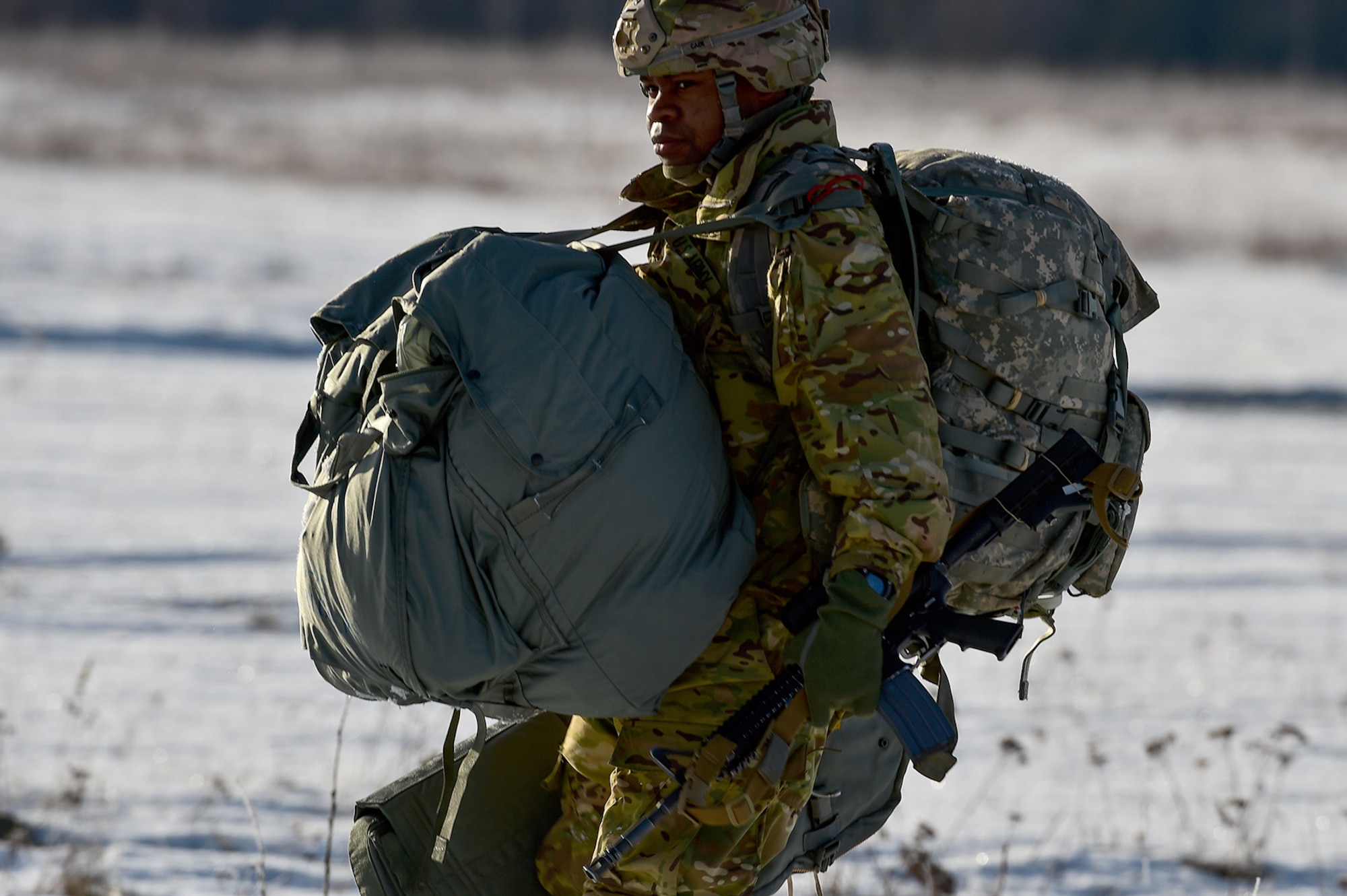 U.S. Army Sgt. Johnnatan Cain, assigned to the 6th Brigade Engineer Battalion (Airborne), 4th Infantry Brigade Combat Team (Airborne), 25th Infantry Division, U.S. Army Alaska,  walks across the drop zone after an airborne training jump from a CH-47 Chinook helicopter on Malemute drop zone at Joint Base Elmendorf-Richardson, Alaska, Thursday, Nov. 3, 2016. The Soldiers of 4/25 IBCT belong to the only American airborne brigade in the Pacific and are trained to execute airborne maneuvers in extreme cold weather/high altitude environments in support of combat, partnership and disaster relief operations. 