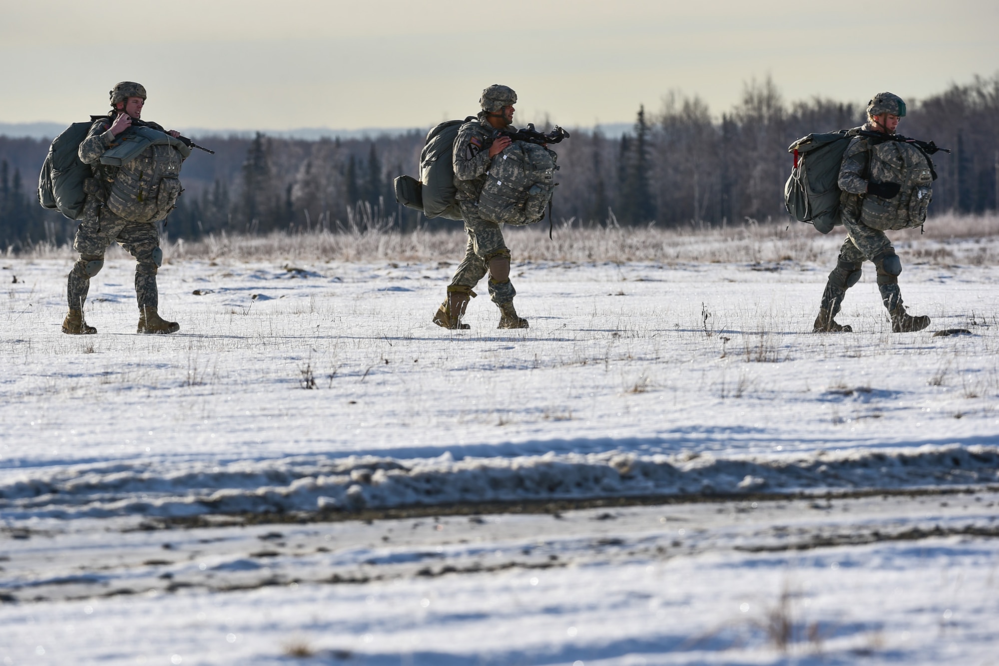 U.S. Army paratroopers assigned to the 4th Infantry Brigade Combat Team (Airborne), 25th Infantry Division, U.S. Army Alaska, walk across the drop zone after executing an airborne training jump from a CH-47 Chinook helicopter on Malemute drop zone at Joint Base Elmendorf-Richardson, Alaska, Thursday, Nov. 3, 2016. The Soldiers of 4/25 IBCT belong to the only American airborne brigade in the Pacific and are trained to execute airborne maneuvers in extreme cold weather/high altitude environments in support of combat, partnership and disaster relief operations. 