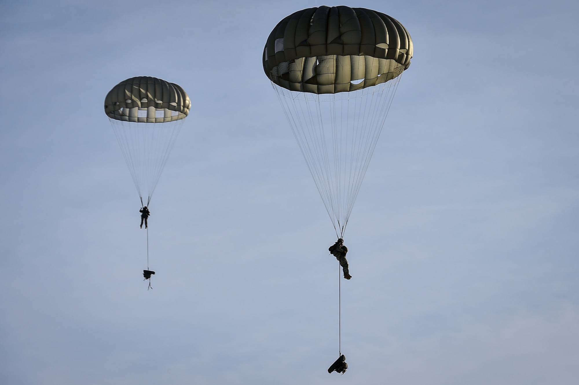 U.S. Army paratroopers assigned to the 4th Infantry Brigade Combat Team (Airborne), 25th Infantry Division, U.S. Army Alaska, prepare to land during an airborne training jump from CH-47 Chinook helicopters on Malemute drop zone at Joint Base Elmendorf-Richardson, Alaska, Thursday, Nov. 3, 2016. The Soldiers of 4/25 IBCT belong to the only American airborne brigade in the Pacific and are trained to execute airborne maneuvers in extreme cold weather/high altitude environments in support of combat, partnership and disaster relief operations. 