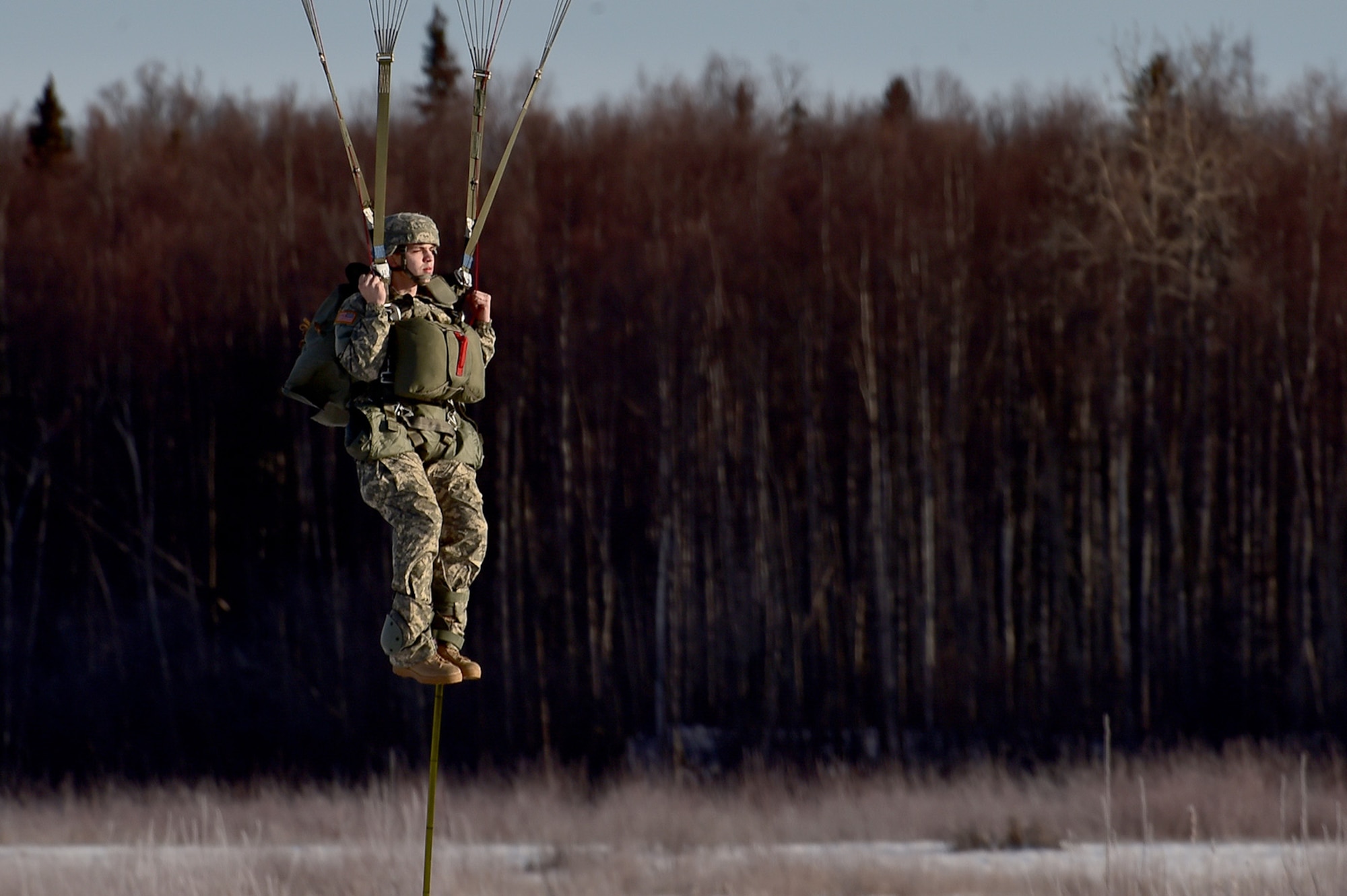 A U.S. Army paratrooper assigned to the 4th Infantry Brigade Combat Team (Airborne), 25th Infantry Division, U.S. Army Alaska, prepares to execute a parachute landing fall during an airborne training jump from a CH-47 Chinook helicopter on Malemute drop zone at Joint Base Elmendorf-Richardson, Alaska, Thursday, Nov. 3, 2016. The Soldiers of 4/25 IBCT belong to the only American airborne brigade in the Pacific and are trained to execute airborne maneuvers in extreme cold weather/high altitude environments in support of combat, partnership and disaster relief operations.