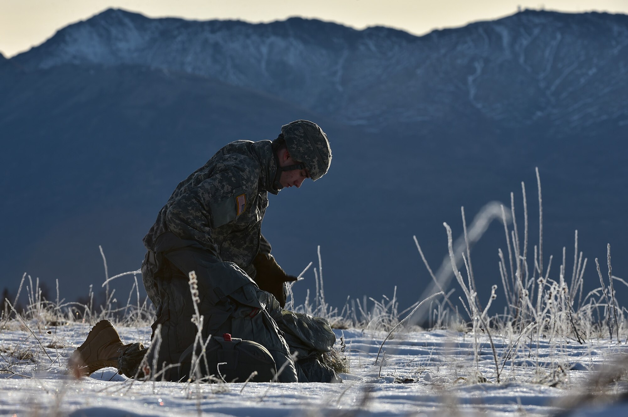 U.S. Army Pfc. Zeke Daggett, a native of Greenville, NY, assigned to 4th Quartermaster Company, 725th Brigade Support Battalion (Airborne), 4th Infantry Brigade Combat Team (Airborne), 25th Infantry Division, U.S. Army Alaska, packs up his parachute after executing an airborne training jump from a CH-47 Chinook helicopter on Malemute drop zone at Joint Base Elmendorf-Richardson, Alaska, Thursday, Nov. 3, 2016. The Soldiers of 4/25 IBCT belong to the only American airborne brigade in the Pacific and are trained to execute airborne maneuvers in extreme cold weather/high altitude environments in support of combat, partnership and disaster relief operations. 