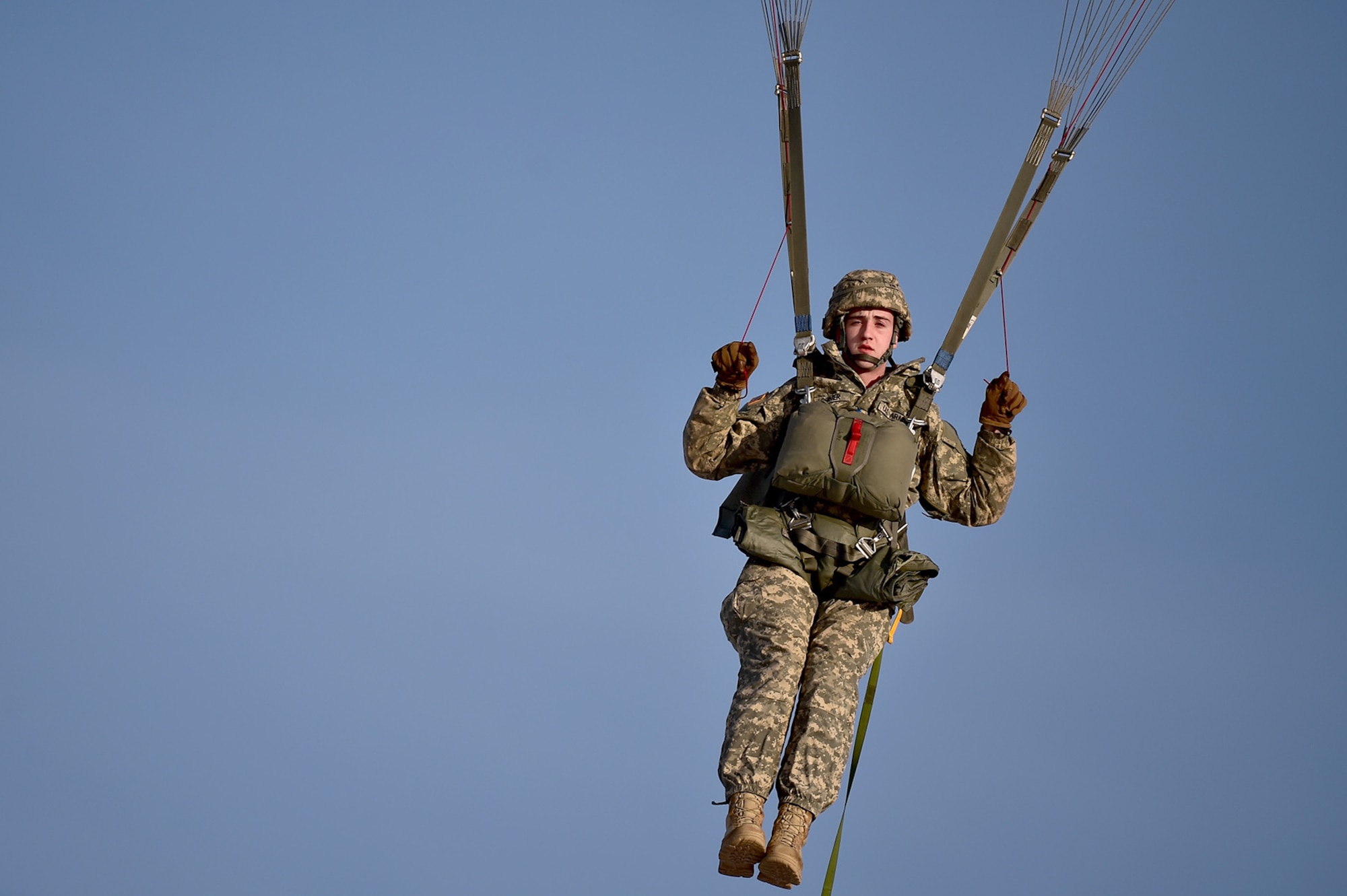 U.S. Army Pfc. Connar Lorimer, a native of Longview, Wash., assigned to Headquarters and Headquarters Company, 725th Brigade Support Battalion (Airborne), 4th Infantry Brigade Combat Team (Airborne), 25th Infantry Division, U.S. Army Alaska, prepares to land after executing an airborne training jump from a CH-47 Chinook helicopter on Malemute drop zone at Joint Base Elmendorf-Richardson, Alaska, Thursday, Nov. 3, 2016. The Soldiers of 4/25 IBCT belong to the only American airborne brigade in the Pacific and are trained to execute airborne maneuvers in extreme cold weather/high altitude environments in support of combat, partnership and disaster relief operations. 