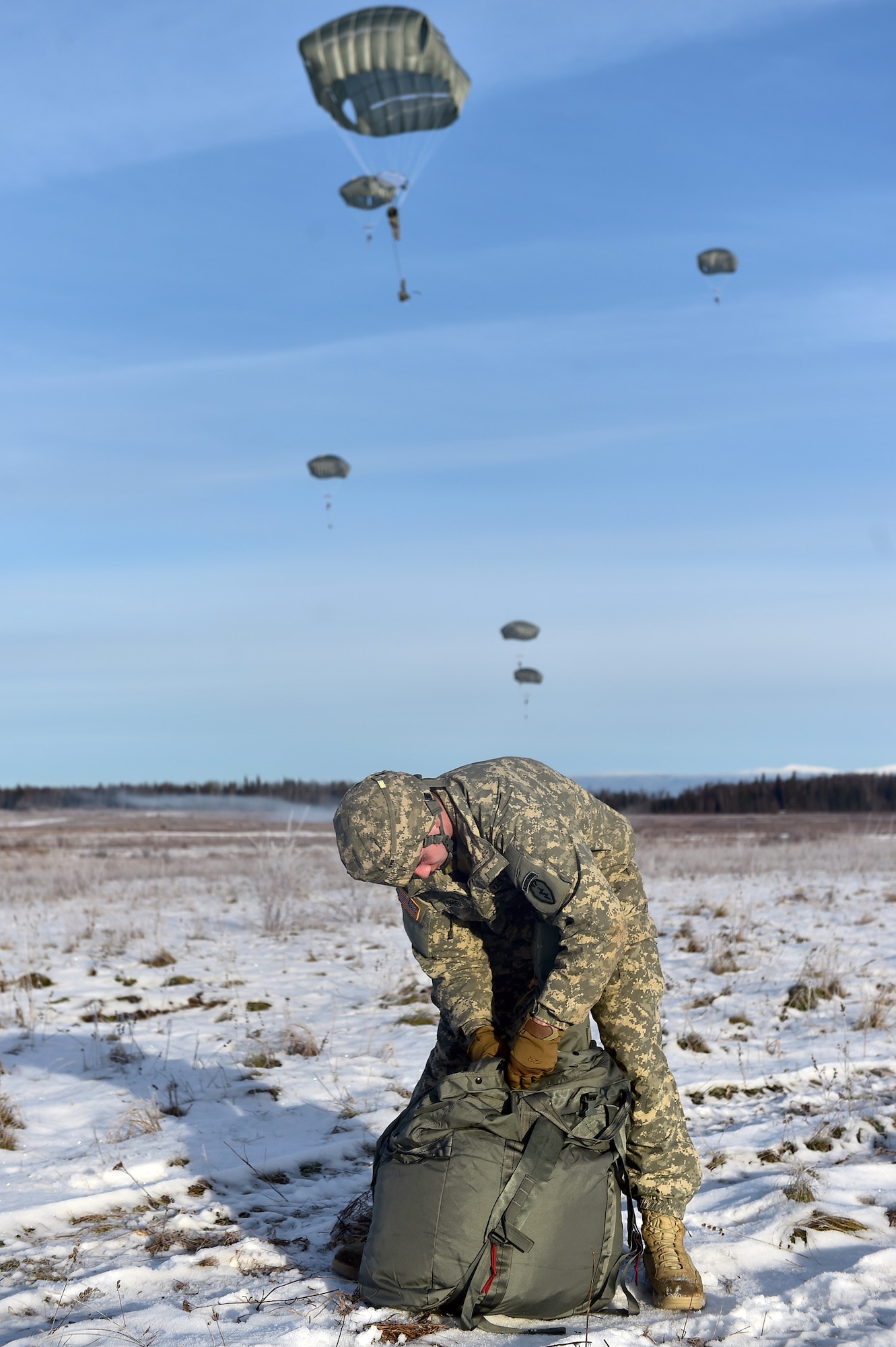 U.S. Army Pfc. Connar Lorimer, a native of Longview, Wash., assigned to Headquarters and Headquarters Company, 725th Brigade Support Battalion (Airborne), 4th Infantry Brigade Combat Team (Airborne), 25th Infantry Division, U.S. Army Alaska, packs up his parachute after executing an airborne training jump from a CH-47 Chinook helicopter on Malemute drop zone at Joint Base Elmendorf-Richardson, Alaska, Thursday, Nov. 3, 2016. The Soldiers of 4/25 IBCT belong to the only American airborne brigade in the Pacific and are trained to execute airborne maneuvers in extreme cold weather/high altitude environments in support of combat, partnership and disaster relief operations. 