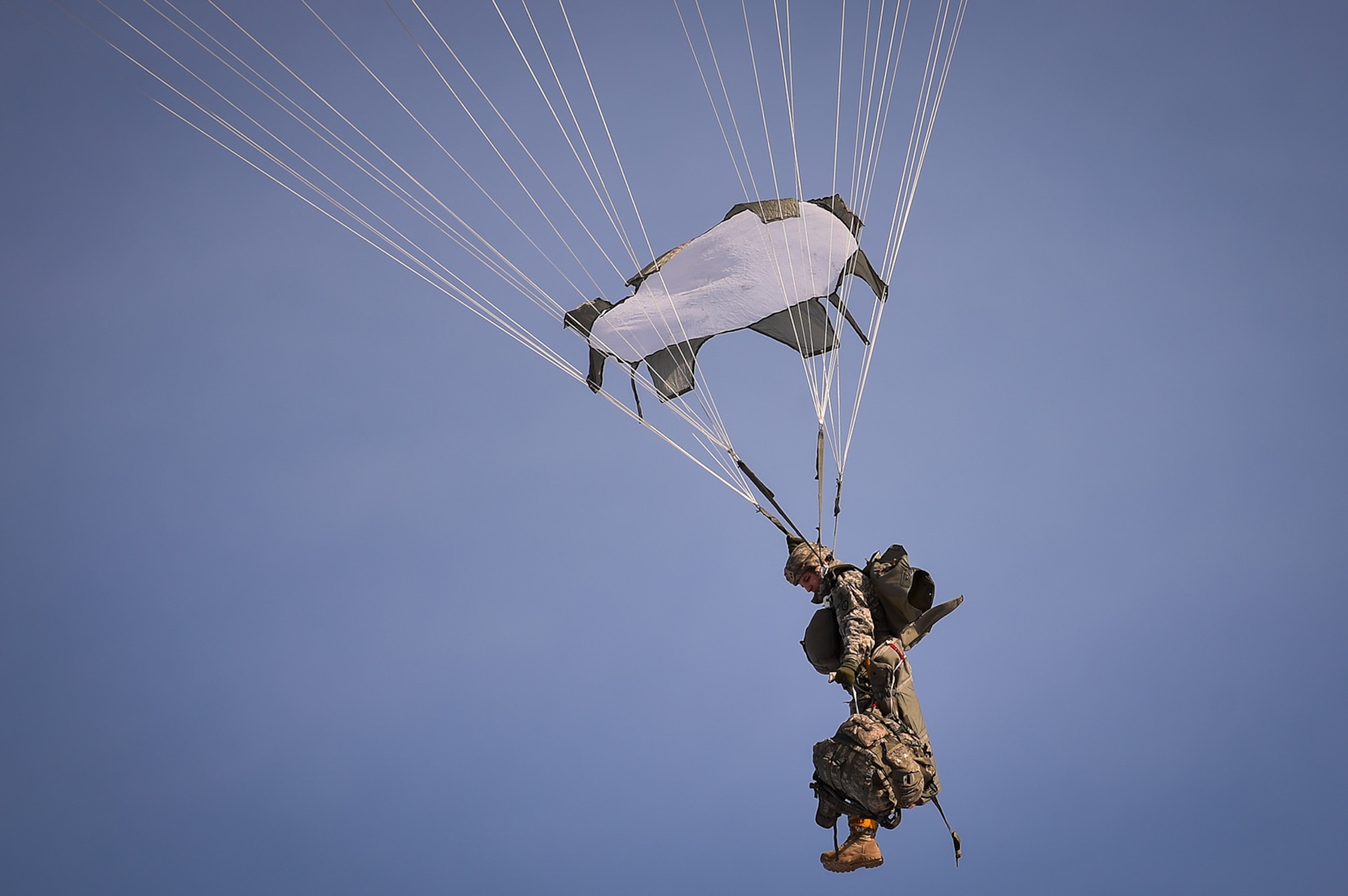 A U.S. Army paratrooper assigned to the 4th Infantry Brigade Combat Team (Airborne), 25th Infantry Division, U.S. Army Alaska, prepares to lower his combat equipment during an airborne training jump from a CH-47 Chinook helicopter on Malemute drop zone at Joint Base Elmendorf-Richardson, Alaska, Thursday, Nov. 3, 2016. The Soldiers of 4/25 IBCT belong to the only American airborne brigade in the Pacific and are trained to execute airborne maneuvers in extreme cold weather/high altitude environments in support of combat, partnership and disaster relief operations.