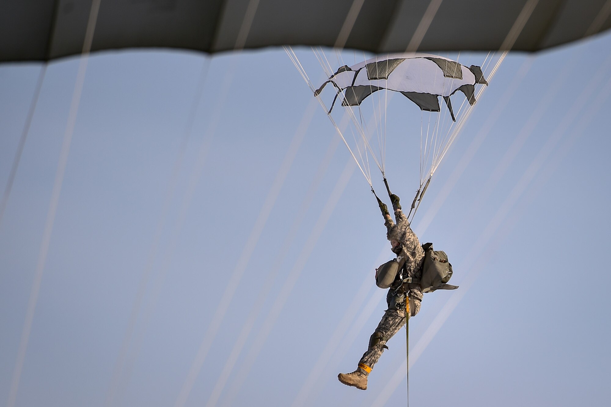 A U.S. Army paratrooper assigned to the 4th Infantry Brigade Combat Team (Airborne), 25th Infantry Division, U.S. Army Alaska, prepares to land during an airborne training jump from a CH-47 Chinook helicopter on Malemute drop zone at Joint Base Elmendorf-Richardson, Alaska, Thursday, Nov. 3, 2016. The Soldiers of 4/25 IBCT belong to the only American airborne brigade in the Pacific and are trained to execute airborne maneuvers in extreme cold weather/high altitude environments in support of combat, partnership and disaster relief operations. 