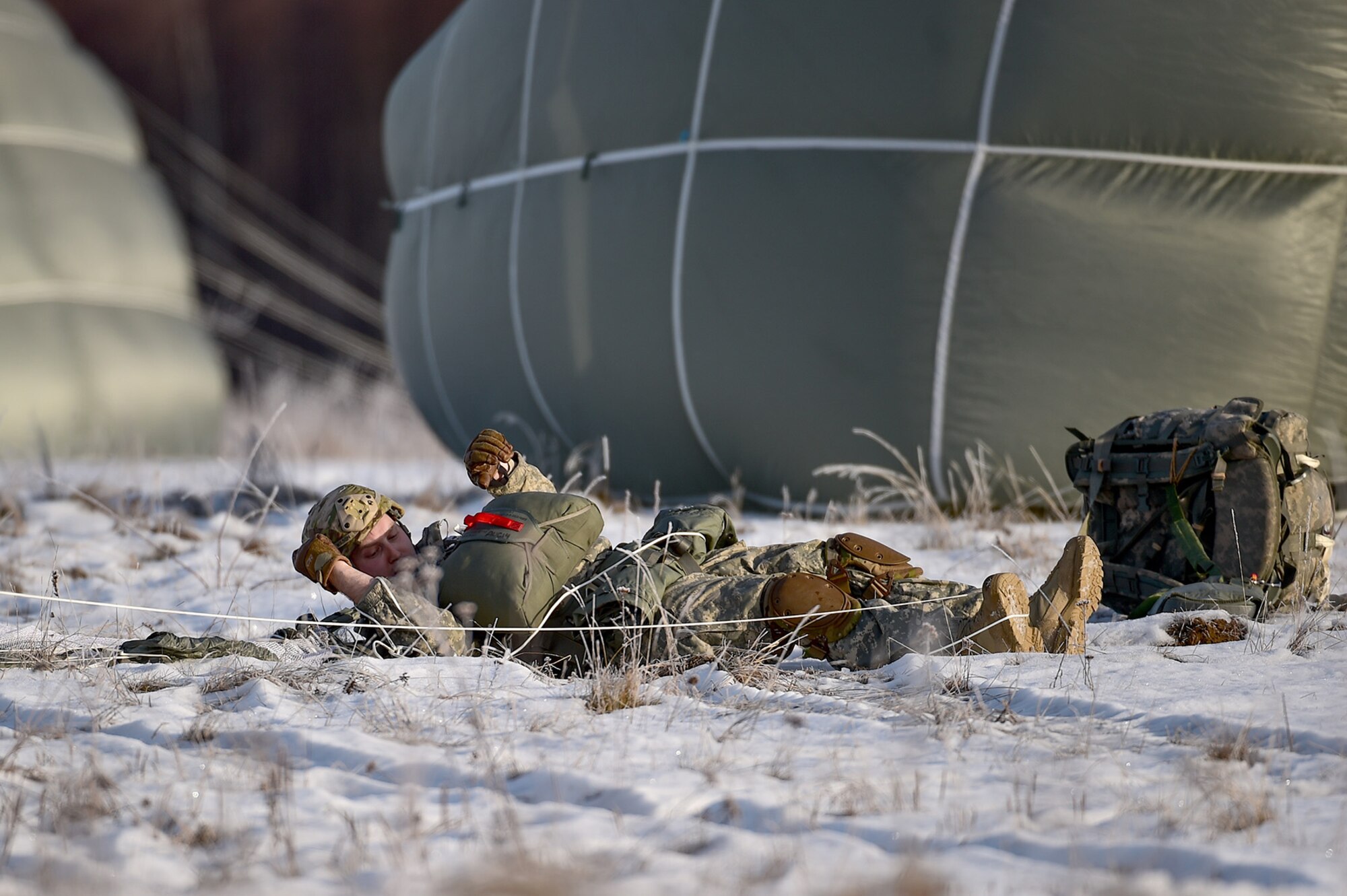 U.S. Army Sgt. Andrew Wilson, a native of Grass Valley, Calif., assigned to the 4th Infantry Brigade Combat Team (Airborne), 25th Infantry Division, U.S. Army Alaska, removes his equipment after an airborne training jump from a CH-47 Chinook helicopter on Malemute drop zone at Joint Base Elmendorf-Richardson, Alaska, Thursday, Nov. 3, 2016. The Soldiers of 4/25 IBCT belong to the only American airborne brigade in the Pacific and are trained to execute airborne maneuvers in extreme cold weather/high altitude environments in support of combat, partnership and disaster relief operations. 