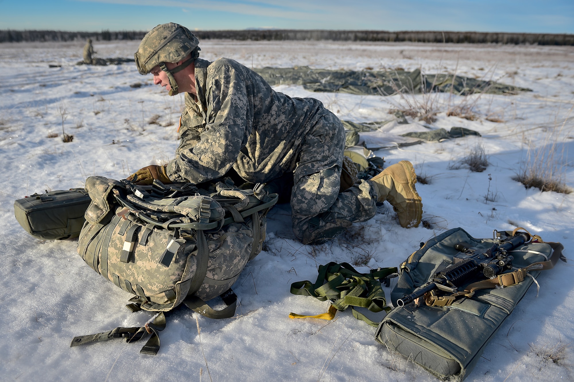 U.S. Army Sgt. Richard McPherson, a native of Dallas, Texas, assigned to the 4th Infantry Brigade Combat Team (Airborne), 25th Infantry Division, U.S. Army Alaska, secures his equipment after executing an airborne training jump from a CH-47 Chinook helicopter on Malemute drop zone at Joint Base Elmendorf-Richardson, Alaska, Thursday, Nov. 3, 2016. The Soldiers of 4/25 IBCT belong to the only American airborne brigade in the Pacific and are trained to execute airborne maneuvers in extreme cold weather/high altitude environments in support of combat, partnership and disaster relief operations.