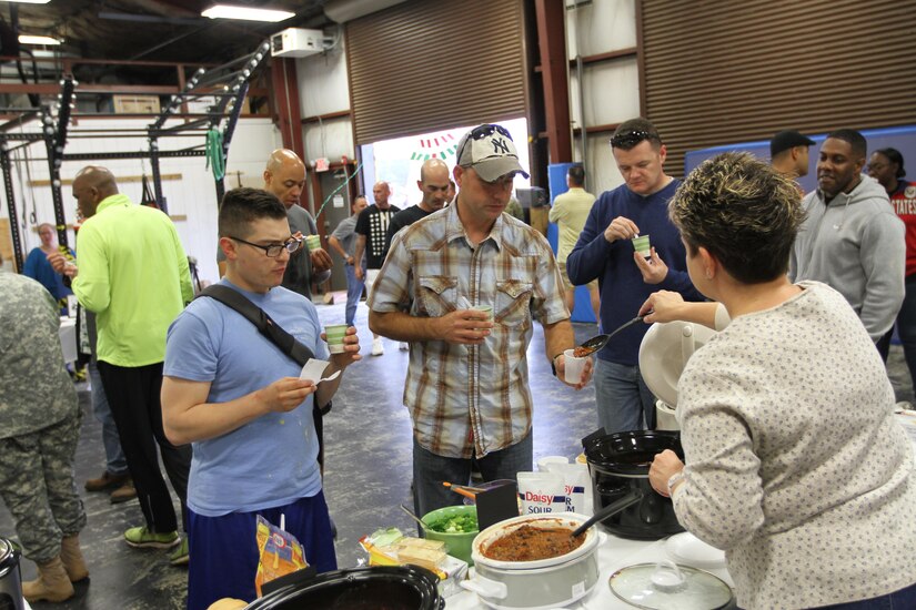 U.S. Army Central Soldiers taste chili during the USARCENT Organization Day chili cook-off Nov. 4, at the Shaw Air Force Base Fight House. Soldiers had a choice of 19 different homemade chilies prepared by Soldiers and Family members. 