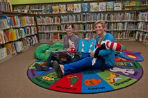 (From left) Julie Reiten, 5th Force Support Squadron, and Ellyn Dunford, spouse to the Chairman Joint Chiefs of Staff, sit with books and stuffed animals in the library at Minot Air Force Base, N.D., Nov. 2, 2016. Dunford toured Minot AFB library and was briefed on its various reading programs. (U.S. Air Force photo/Airman 1st Class Jonathan McElderry)