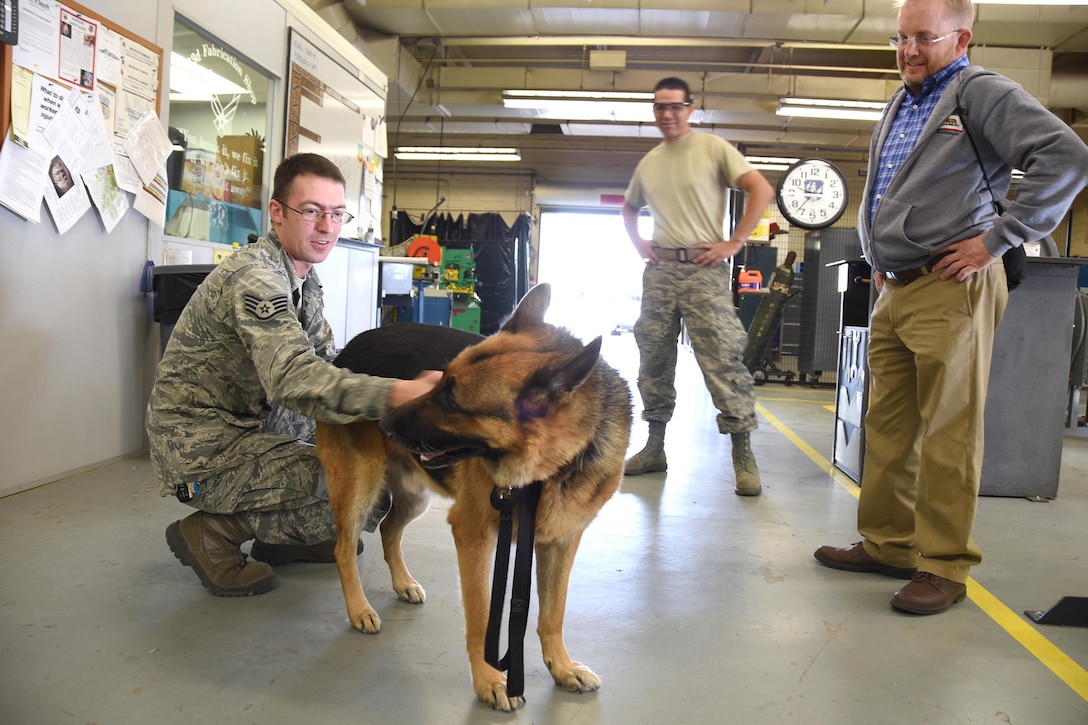 David Cunningham, the 163rd Attack Wing director of Psychological Health (DPH), visits with Airmen in their work centers before the holidays to meet and greet along with his German Shepherd, Jax, who is finishing the courses to soon be the 163rd Attack Wing therapy dog. (U.S. Air National Guard Photo by Master Sgt. Julie Avey)