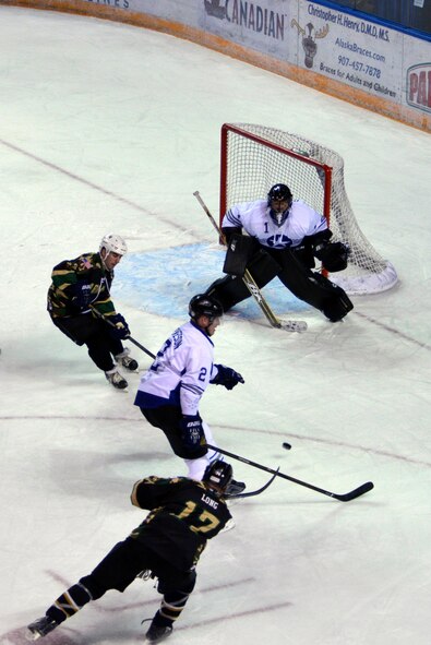 U.S. Air Force Senior Airman Stanislav Barilov, a 213th Space Warning Squadron patrolman, defends his goal during the 22nd annual Army versus Air Force Hockey game Nov. 5, 2016, at the Carlson Center in Fairbanks, Alaska. The puck was successfully deflected, preventing the Army from scoring a goal. (U.S. Air Force photo by Airman Eric M. Fisher)