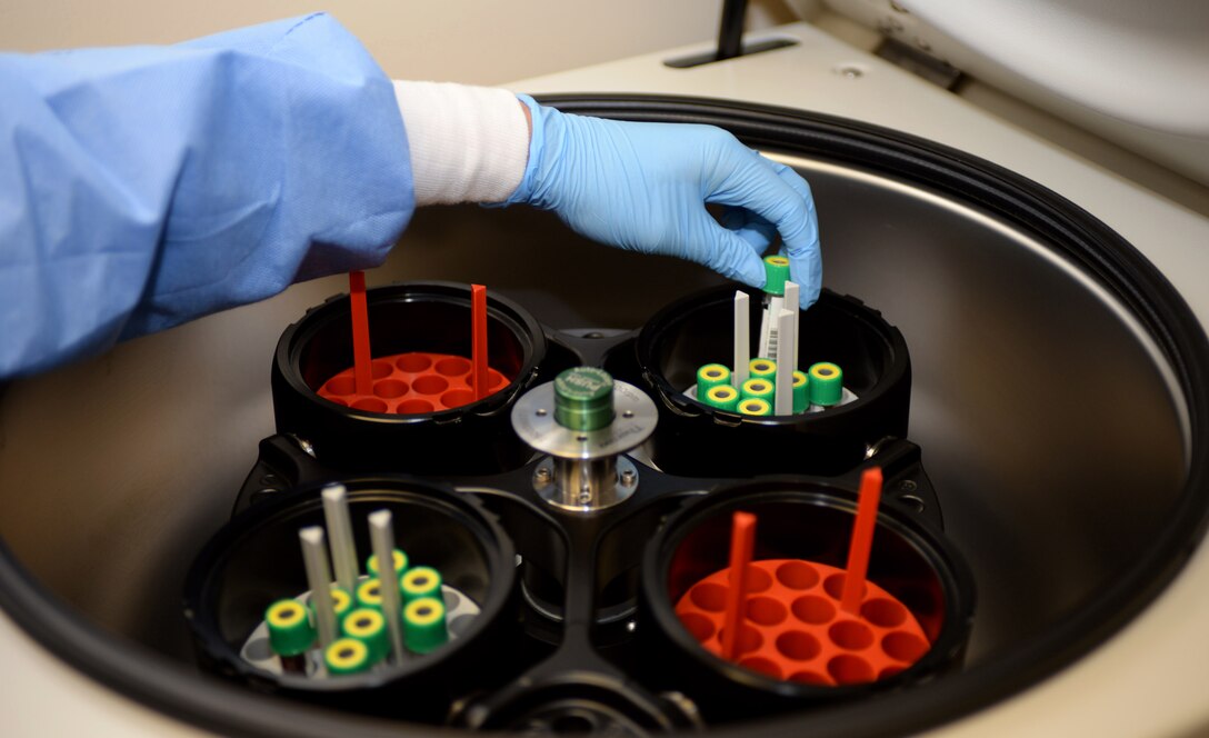 Airman 1st Class Kristen Lowder, a medical laboratory technician assigned to the 28th Medical Support Squadron, places a blood sample into a centrifuge at Ellsworth Air Force Base, S.D., Nov. 7, 2016. A centrifuge is a laboratory device that is used to separate fluids, gas or liquid, based on density, and is achieved by spinning a vessel containing the material at high speed. (U.S. Air Force photo by Airman 1st Class Denise M. Jenson)