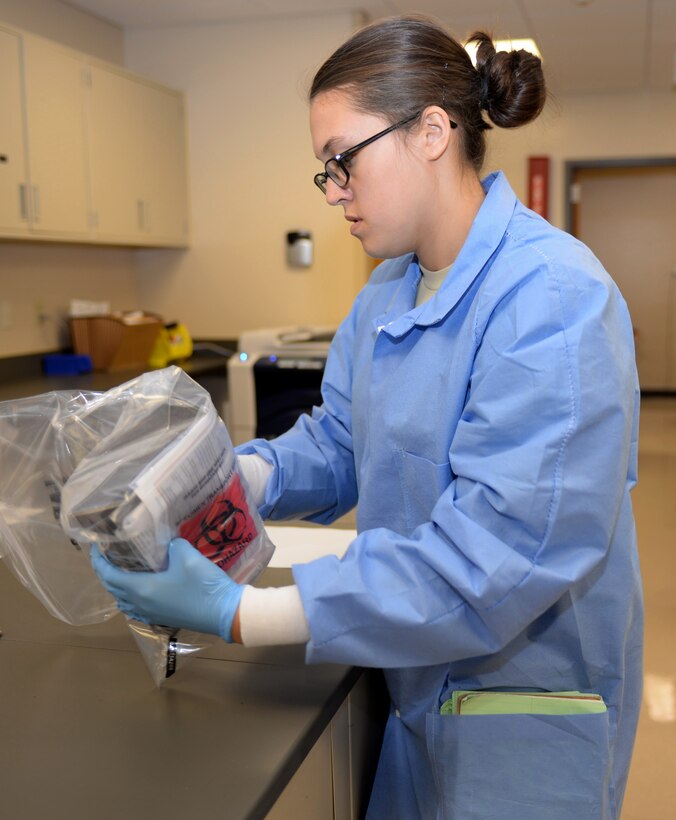 Airman 1st Class Kristen Lowder, a medical laboratory technician assigned to the 28th Medical Support Squadron, finishes packaging a shipment of lab samples at Ellsworth Air Force Base, S.D., Nov. 7, 2016.
When a patient’s samples require more advanced tests, they are packaged and shipped to either local area clinics or Wright Patterson Air Force Base, Ohio. (U.S. Air Force photo by Airman 1st Class Denise M. Jenson)