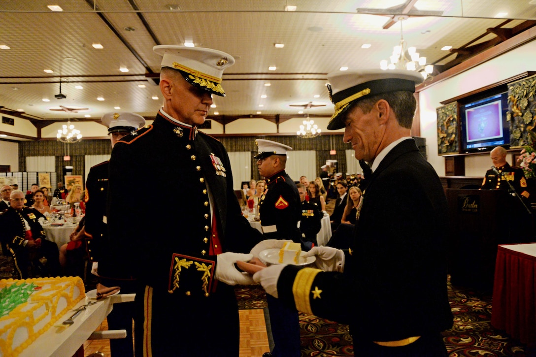 Brig. Gen. John Jansen, Commanding General, 3d Marine Expeditionary Brigade (MEB), passes the first piece of cake to the guest of honor, Rear. Adm. Marc H. Dalton, Commander, Amphibious Force 7th Fleet, as part of tradition during the 3d MEB Marine Corps birthday ball. The event celebrated the Marine Corps’ 241st birthday with a ceremony and dinner. (U.S. Navy photo by Petty Officer 2nd Class Sarah Villegas)