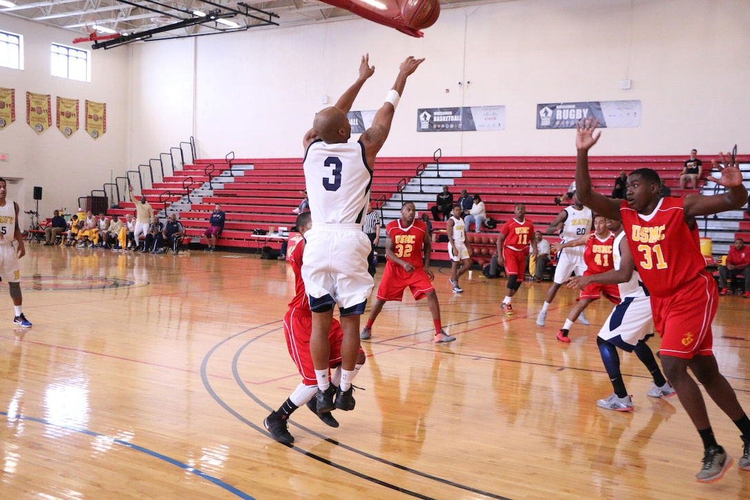 Petty Officer Third Class Derrick Sumpter of the U.S. Coast Guard (#3) shoots one of his eight three-pointers in Navy's defeat over Marine Corps 71-67 in the Consolation Game. Sumpter led the team with 31-points. The 2016 Armed Forces Men's Basketball Championship was held 1-7 November at MCB Quantico, Va. 