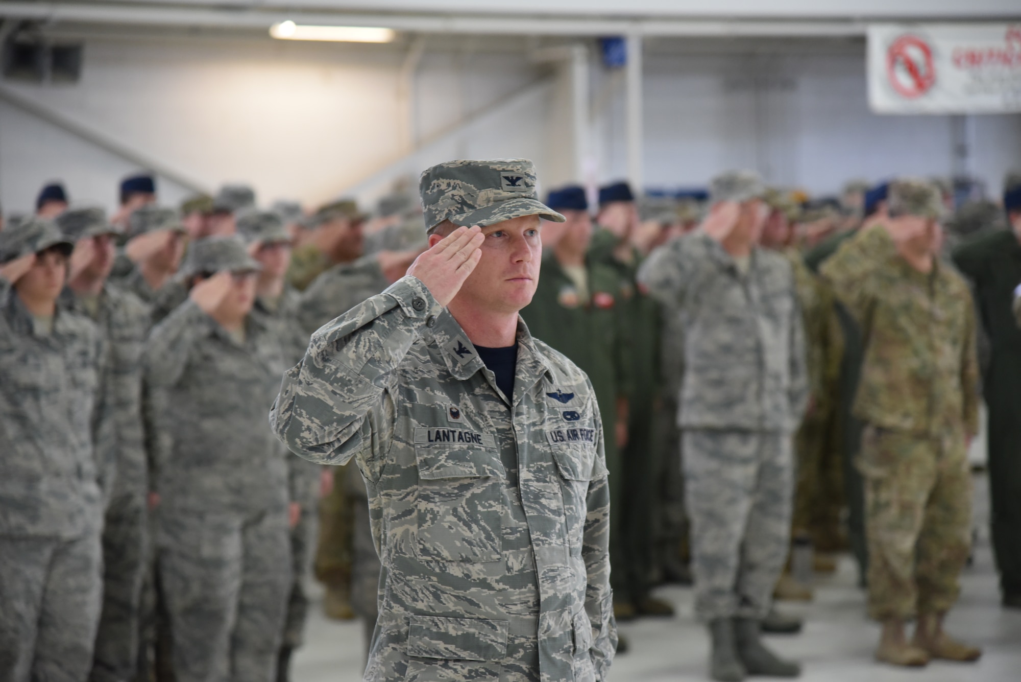 Oregon Air National Guard Col. Christopher Lantagne, 142nd Fighter Wing Maintenance Group commander, center, and other members of the 142nd Fighter Wing render their salute to the colors during the unit's Change of Command ceremony held Nov. 6, 2016, Portland Air National Guard Base, Ore. (U.S. Air National Guard photograph by Senior Master Sgt. Shelly Davison, 142nd Fighter Wing Public Affairs)