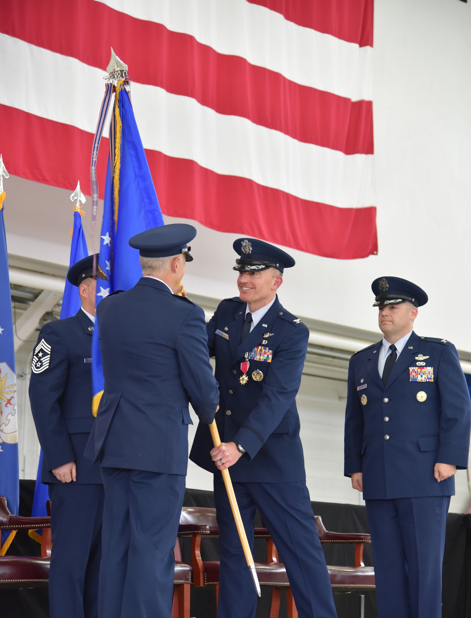 Col. Paul T. Fitzgerald, outgoing 142nd Fighter Wing Commander, hands the Unit Guidon to Maj. Gen. Michael E. Stencel, The Adjutant General, Oregon, as Fitzgerald relinquishes command of the 142nd Fighter Wing during a Change of Command ceremony held Nov. 6, 2016, Portland Air National Guard Base, Ore. (U.S. Air National Guard photograph by Staff Sgt. Brandon Boyd, 142nd Fighter Wing Public Affairs)