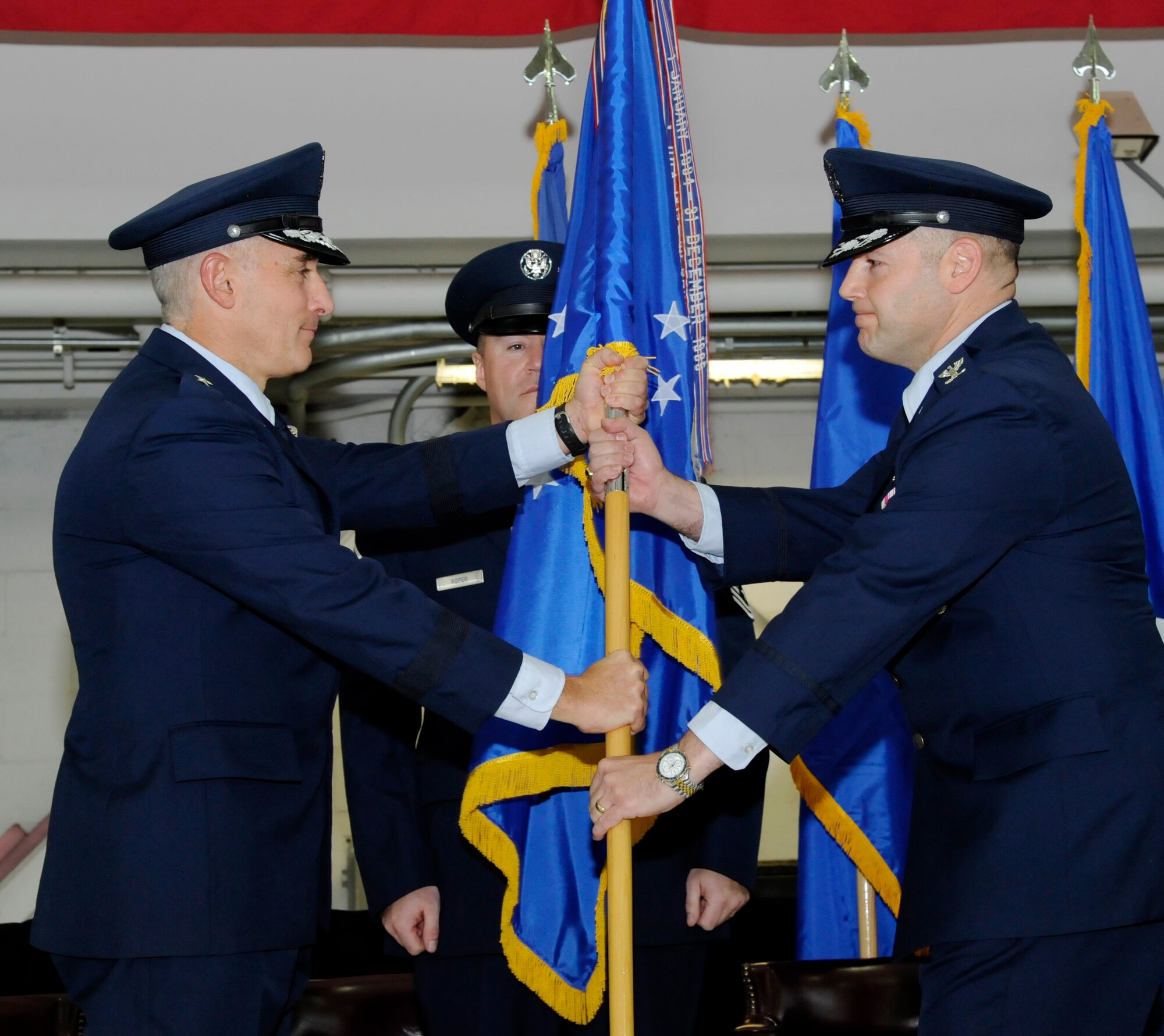 Oregon Air National Guard Brig. Gen. Jeffrey Silver, Oregon Air National Guard commander, left, hands the guidon to incoming 142nd Fighter Wing commander Duke A. Pirak, right, during the formal Change of Command ceremony, Portland Air National Guard Base, Ore., Nov. 6, 2016. (U.S. Air National Guard photo by Tech. Sgt. John Hughel, 142nd Fighter Wing Public Affairs) 