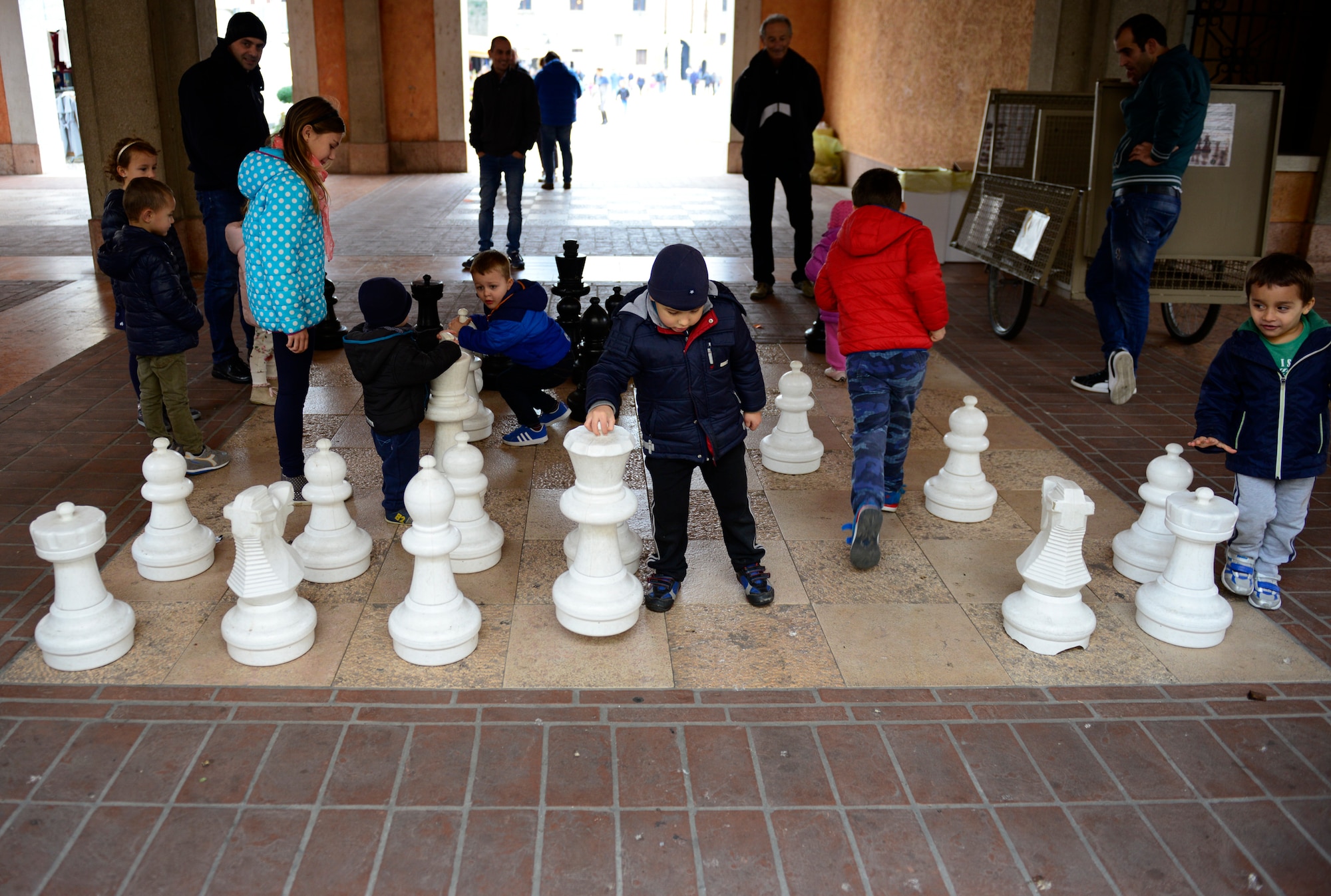 Children play with chess pieces on a chessboard near the city center in Marostica, Italy on Nov. 1, 2016. Marostica is known for its bi-annual, fall, living chess games and annual, spring, cherry festival. (U.S. Air Force photo by Staff Sgt. Krystal Ardrey/Released)