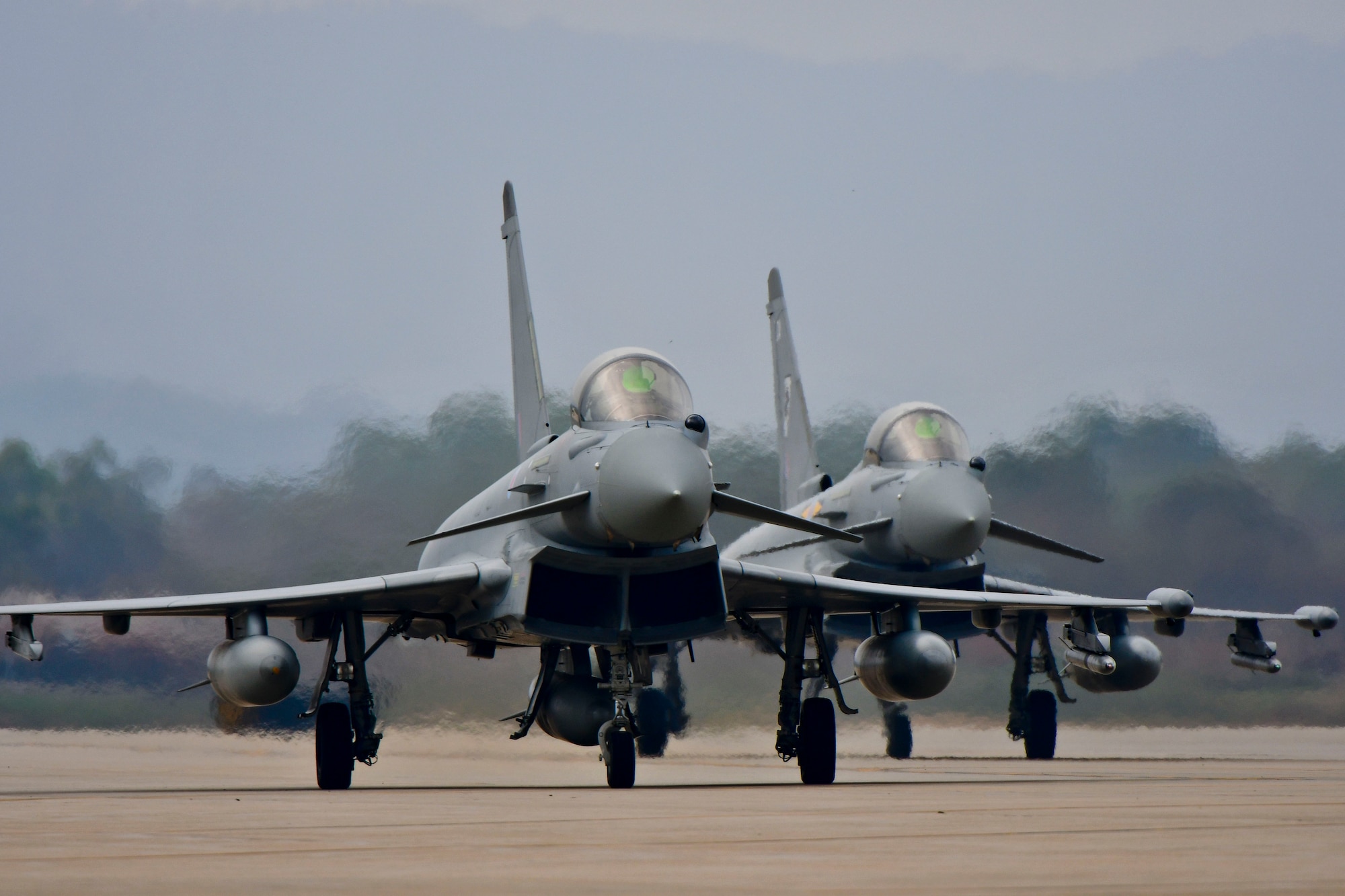 Two Royal Air Force Eurofighter Typhoon FGR4s taxi off of the runway after landing at Osan Air Base, Republic of Korea, Nov. 5, 2016. The arrival of the Typhoons marks the first time the RAF has fielded aircraft on the Korean Peninsula since 1956. (U.S. Air Force photo by Senior Airman Victor J. Caputo)