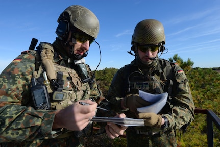 German armed forces Joint Terminal Attack Controllers (JTAC) 1st Lt. Marius Sokol, left, and Capt. Tim Jantzen repeat nine line information to close air support (CAS) F-16 fighter pilots from the 177th Fighter Wing while training at the Warren Grove Bombing Range in Ocean County, N.J., on Oct. 26, 2016. German armed forces JTACs partnered with the New Jersey Air National Guard's 227th Air Support Operations Squadron for a second time in 2016 for a five day combined training exercise which included the CAS training with F-16s and training in the 227th's state of the art $1.2 million Air National Guard Advanced JTAC Training System.  